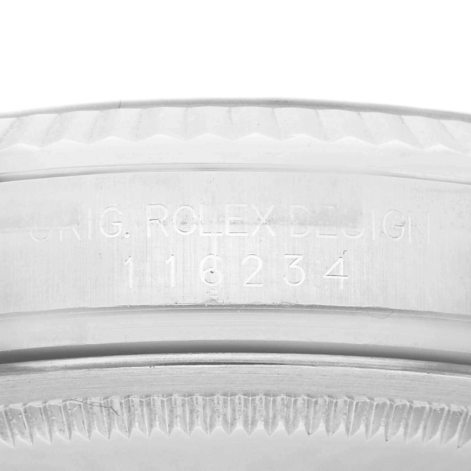 The image shows a close-up of the side of the casing with the serial number and "ORIG. ROLEX DESIGN" engraving of a Rolex Datejust 116234 Men's Stainless Steel Black Dial 116234 Men's Stainless Steel Black Dial watch.