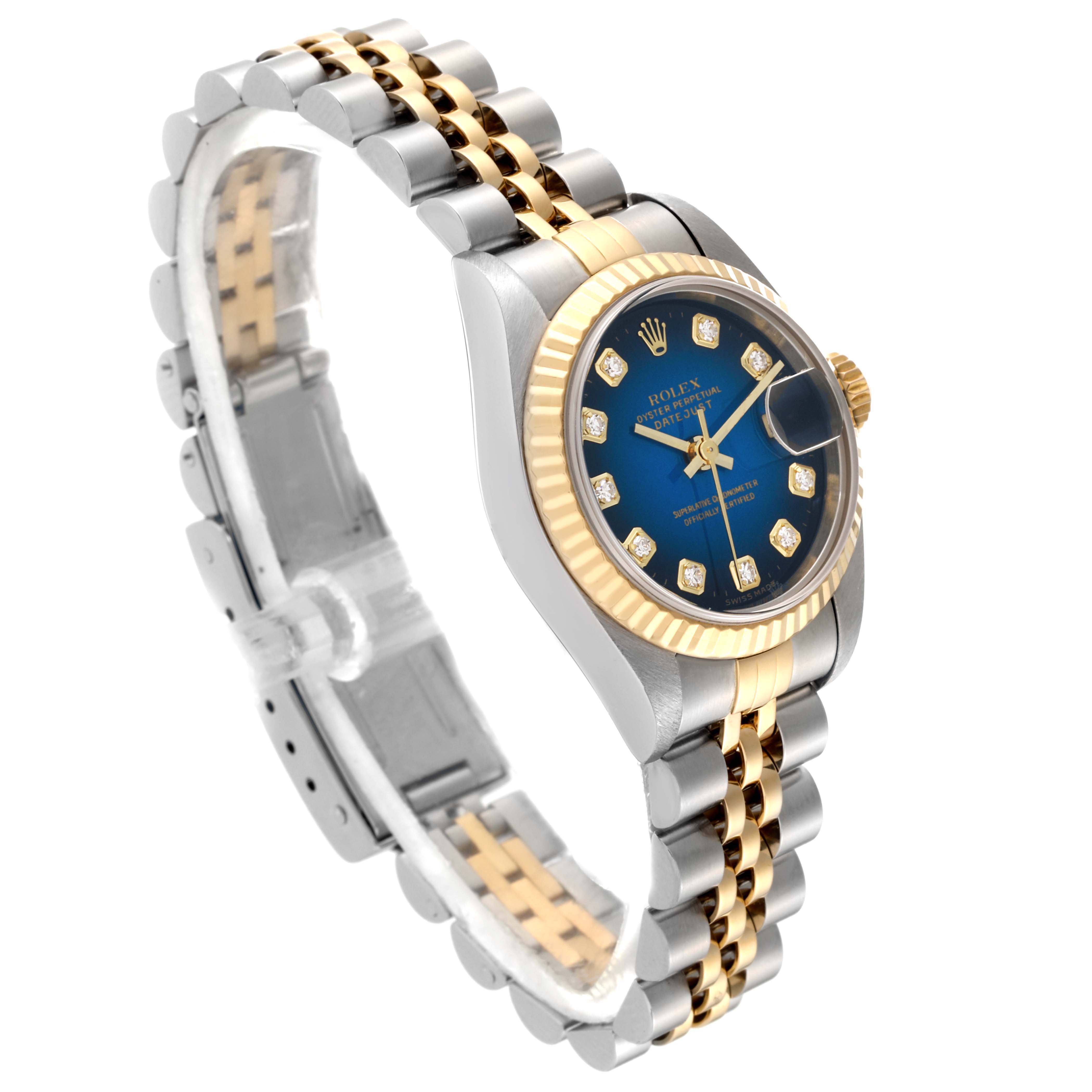 This Rolex Datejust 79173 Women's Steel and Gold (two tone) Blue Dial 79173 Women's Steel and Gold (two tone) Blue Dial watch is shown at a three-quarter angle, highlighting its two-tone bracelet, blue dial, and fluted bezel.