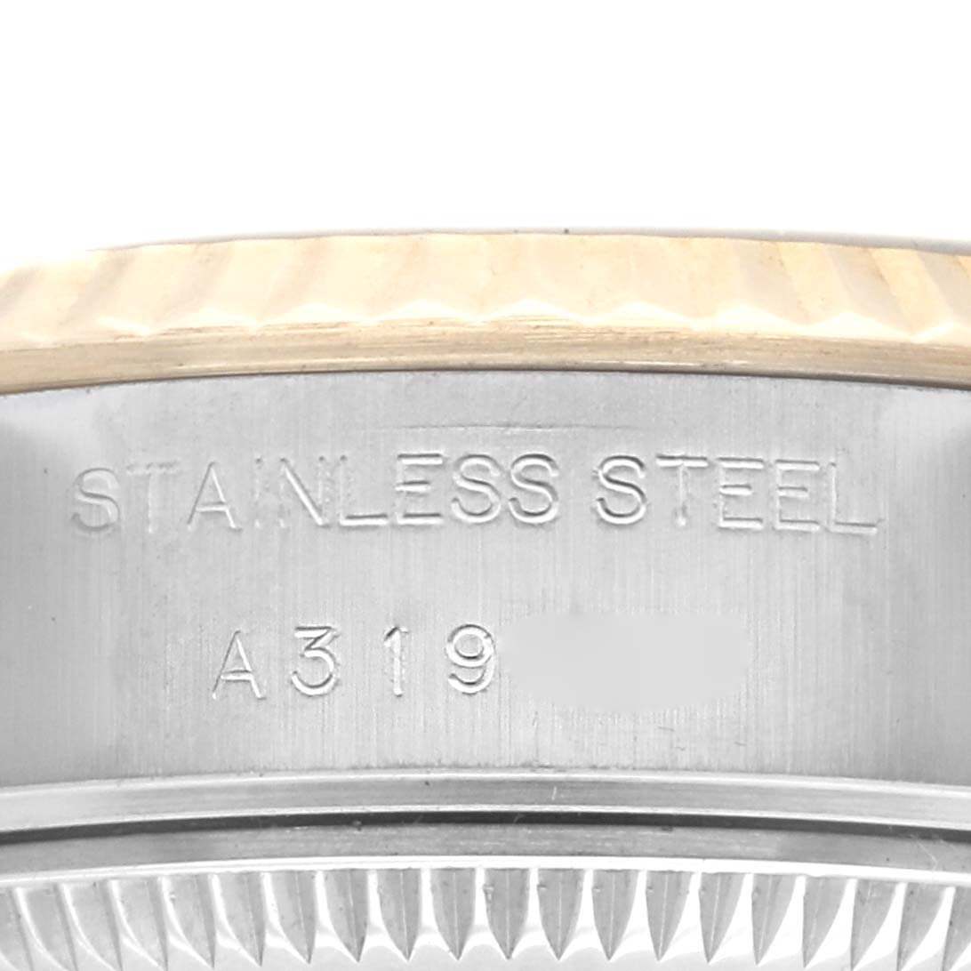 The image shows a close-up of the side engravings and the fluted bezel of a Rolex Datejust 79173 Women's Steel and Gold (two tone) Blue Dial 79173 Women's Steel and Gold (two tone) Blue Dial watch.