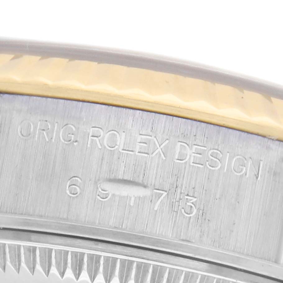 The image shows an angled close-up of the bezel and engraved text on a Rolex Datejust 69173 Women's Steel and Gold (two tone) Champagne Dial 69173 Women's Steel and Gold (two tone) Champagne Dial watch.