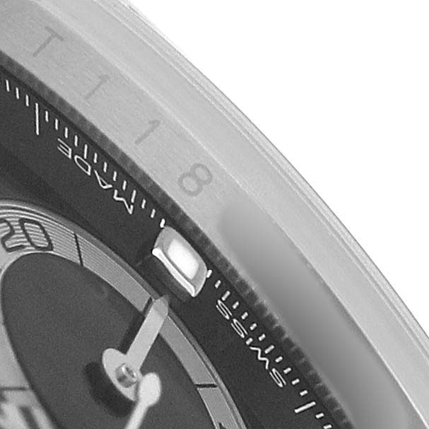 The image shows a close-up of the dial and bezel details of a Rolex Daytona 116500 Men's Stainless Steel Black Dial watch.