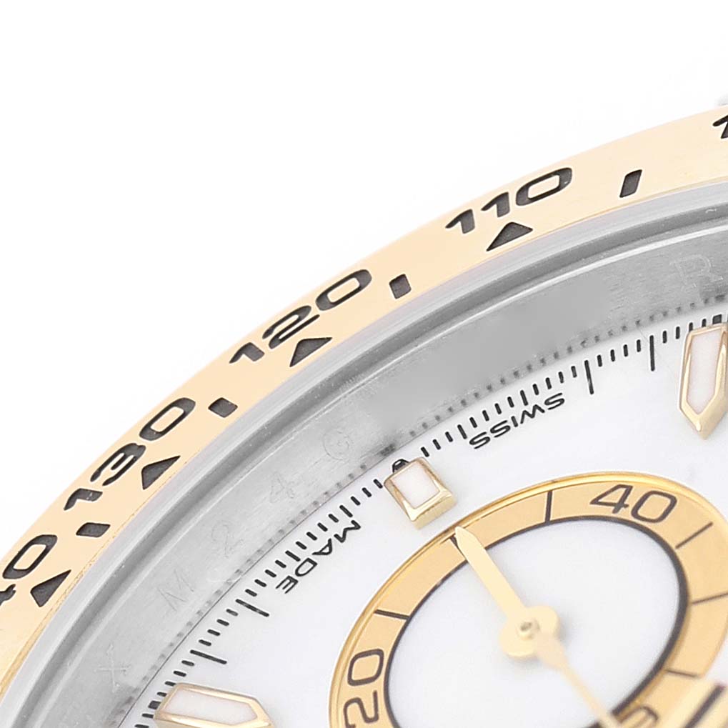 The image shows a close-up of the bezel and partial dial of a Rolex Daytona 126503 Men's Steel and Gold (two tone) White Dial watch, highlighting the tachymetric scale and hour markers.