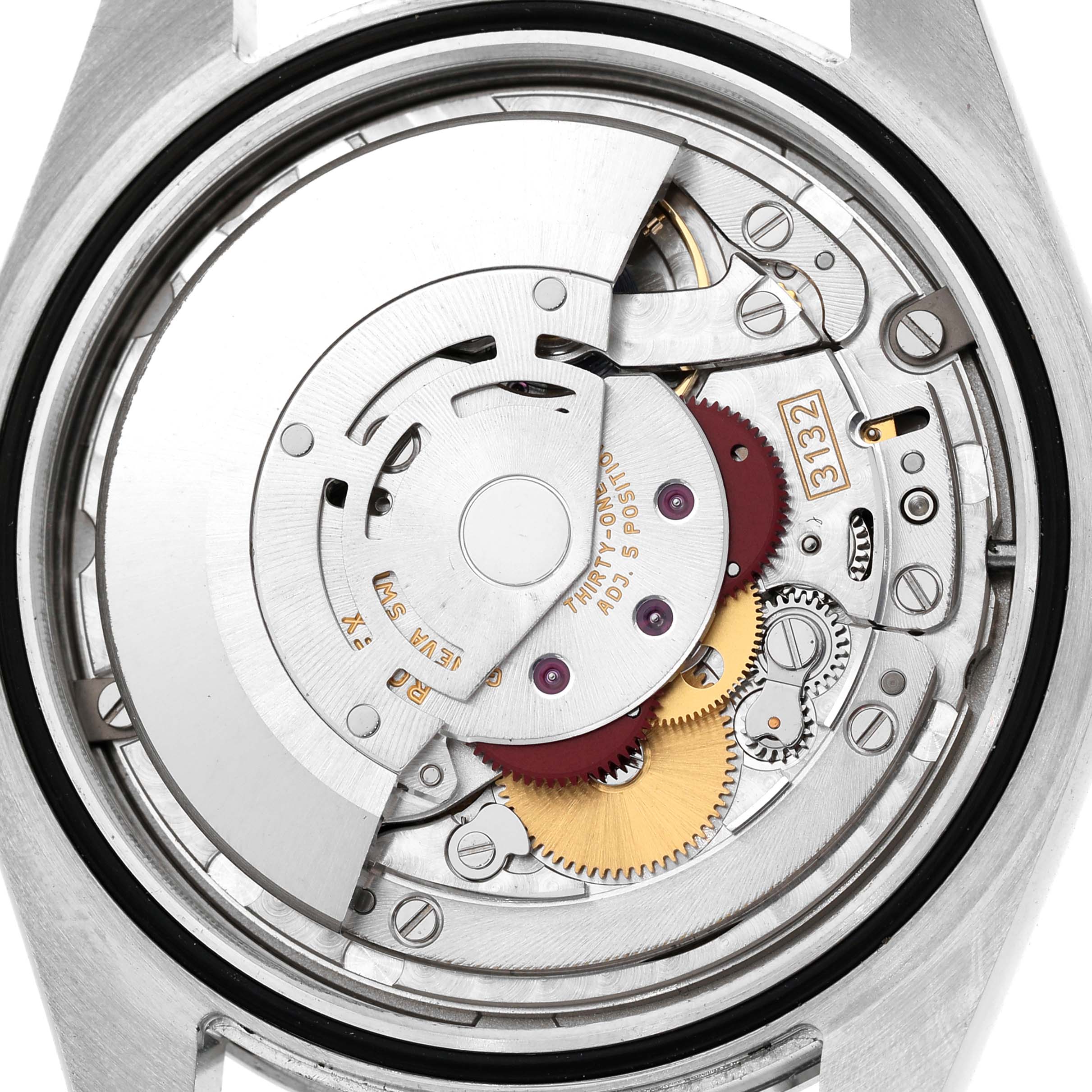 The image shows the movement of a Rolex Explorer 214270 Men's Stainless Steel Black Dial, with gears and components clearly visible from a rear angle.