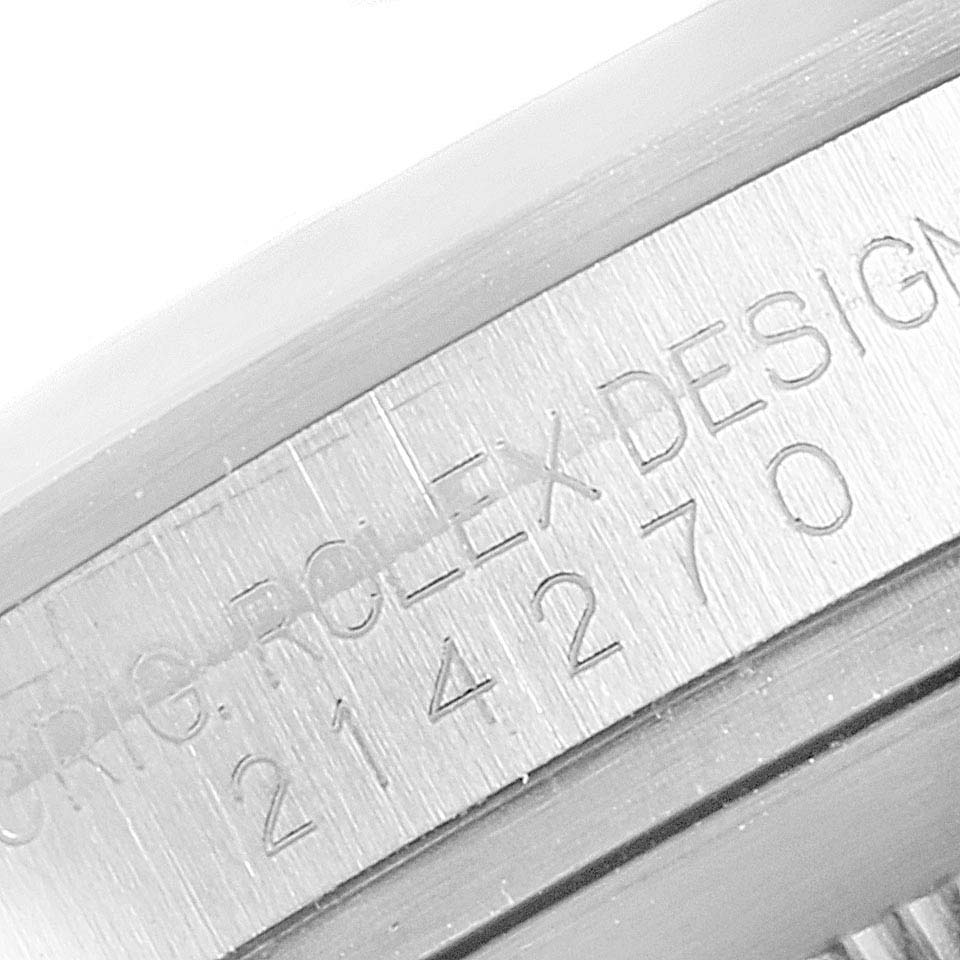 The image shows a close-up of the serial number engraving on the side of a Rolex Explorer 214270 Men
s Stainless Steel Black Dial 214270 Men
s Stainless Steel Black Dial watch case.