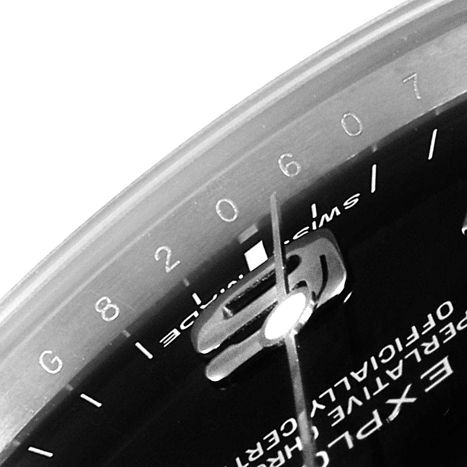 The image shows a partial close-up of the dial and bezel of the Rolex Explorer 214270 Men
s Stainless Steel Black Dial 214270 Men
s Stainless Steel Black Dial watch, highlighting the numbers and part of the text.