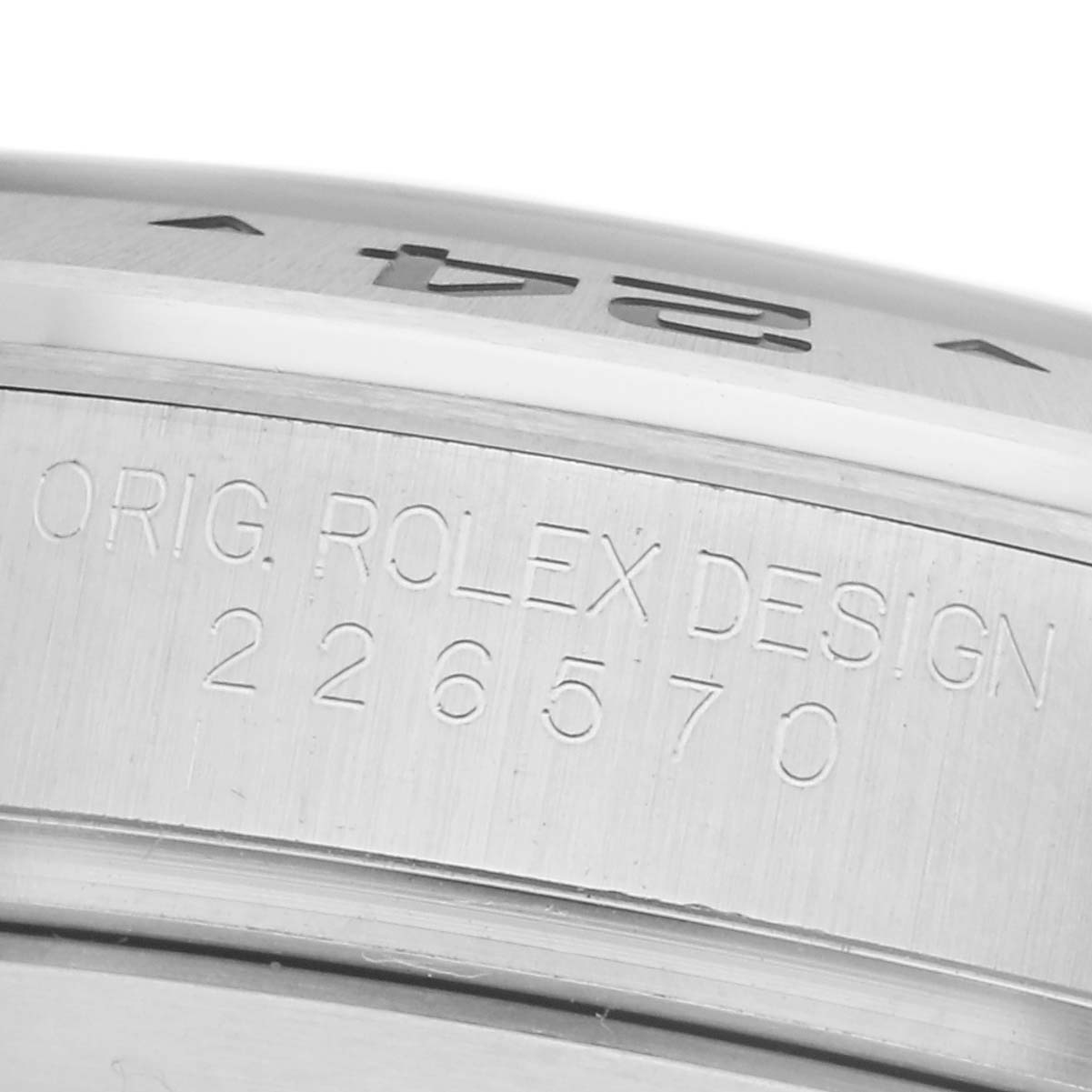The image shows a close-up of the side engraving on the bezel and case of a Rolex Explorer 226570 Men
s Stainless Steel Black Dial 226570 Men
s Stainless Steel Black Dial.