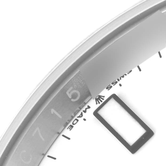 This close-up shot of a Rolex Explorer 226570 Men's Stainless Steel White Dial 226570 Men's Stainless Steel White Dial watch shows part of the bezel, part of the dial, and part of the date window.