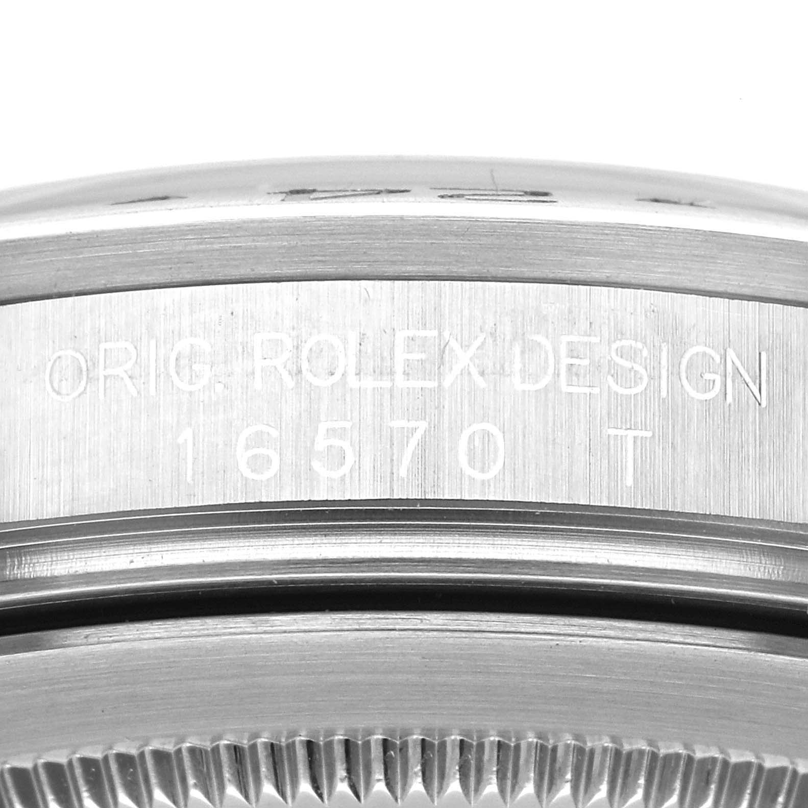 This close-up image shows the side engraving "ORIG ROLEX DESIGN 16570 T" on the bezel of a Rolex Explorer 16570 Men
s Stainless Steel Black Dial 16570 Men
s Stainless Steel Black Dial model watch.