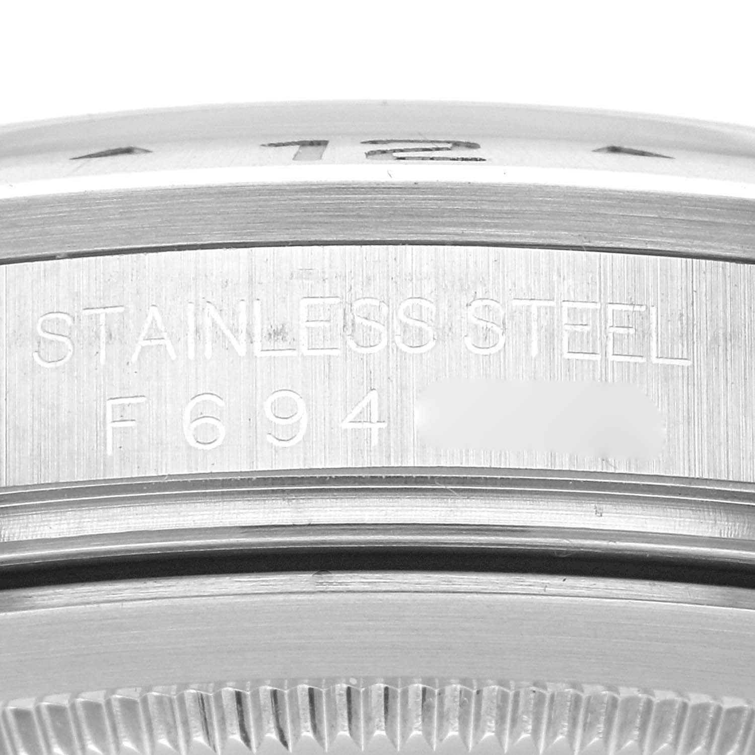 This close-up image of the Rolex Explorer 16570 Men
s Stainless Steel Black Dial 16570 Men
s Stainless Steel Black Dial watch shows the engraved stainless steel case and partial bezel.