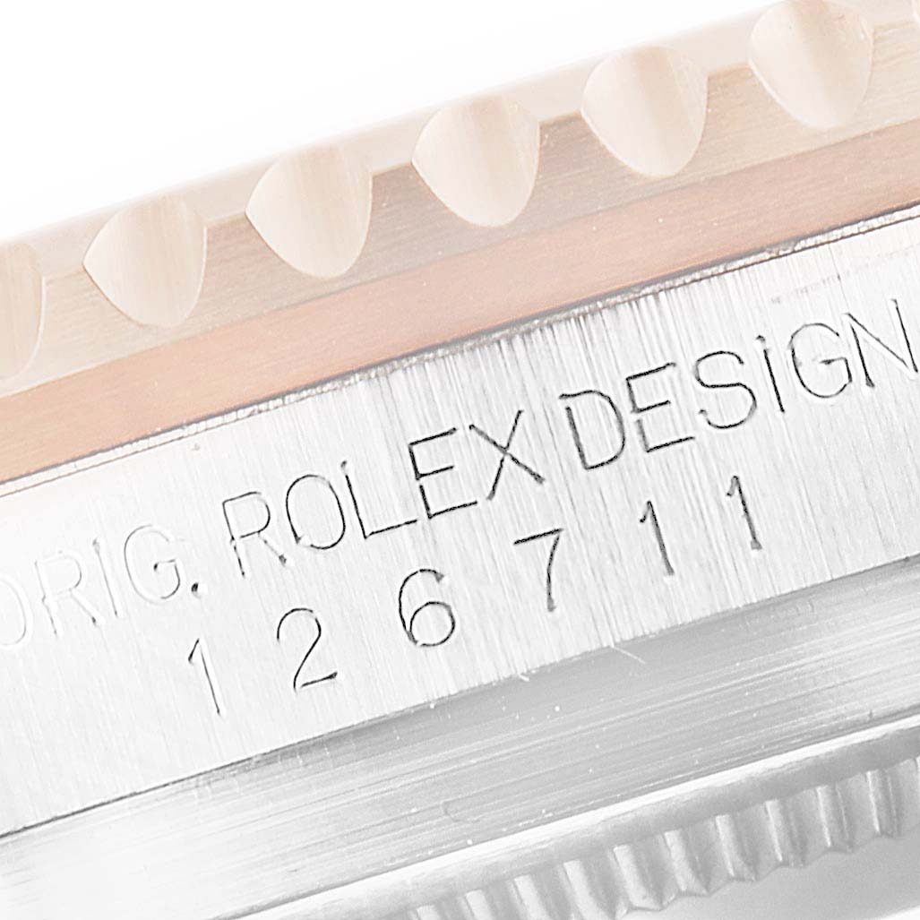 The image shows a close-up of the engraved side of a Rolex GMT-Master 126711 Men's Steel and Gold (two tone) Black Dial 126711 Men's Steel and Gold (two tone) Black Dial, featuring the model number 126711 and part of the bezel.