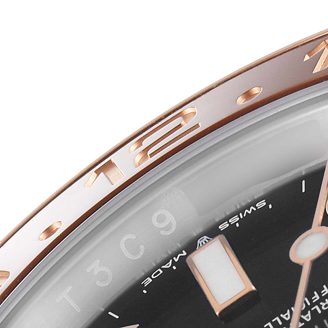The image shows a close-up of the bezel, hour marker, and dial of a Rolex GMT-Master 126711 Men's Steel and Gold (two tone) Black Dial 126711 Men's Steel and Gold (two tone) Black Dial watch.