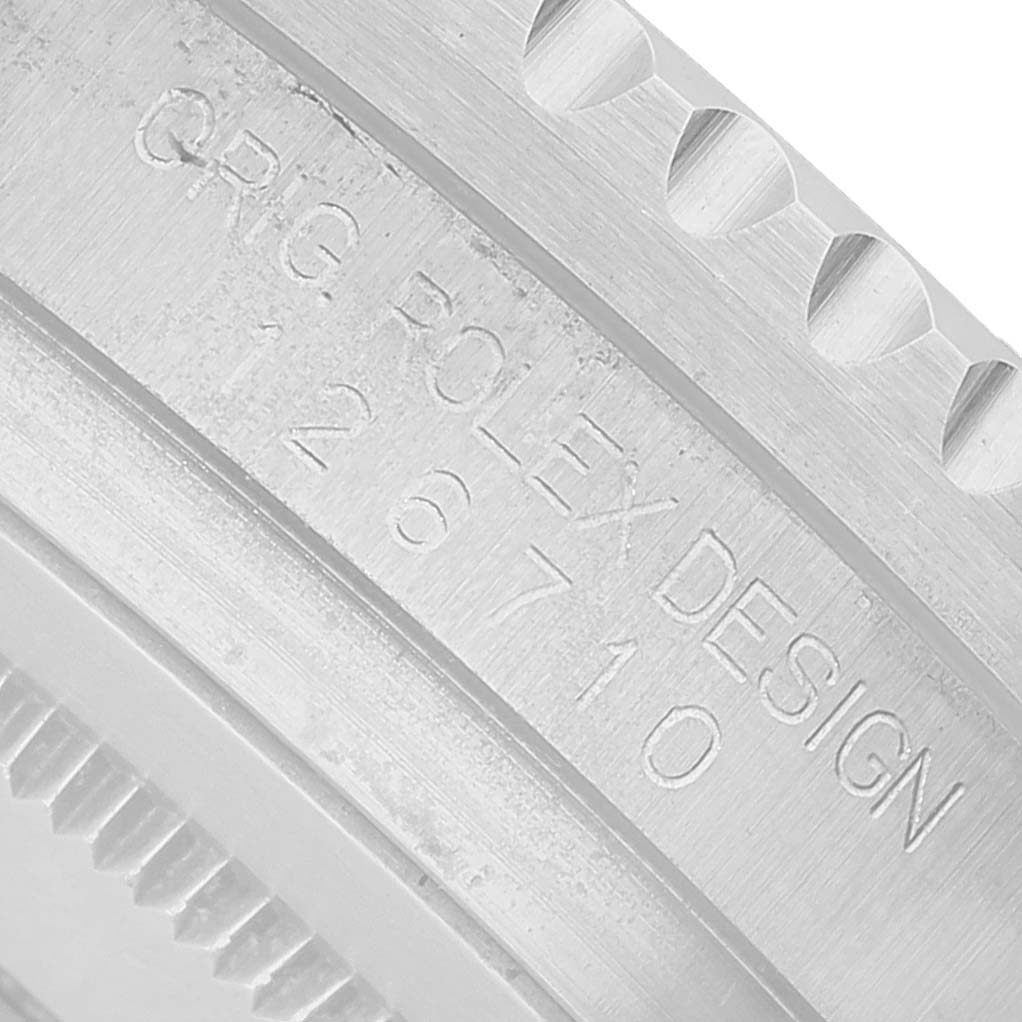 The image shows a close-up of the engraved case side of a Rolex GMT-Master 126710 Men's Stainless Steel Black Dial, displaying the model number and design markings.