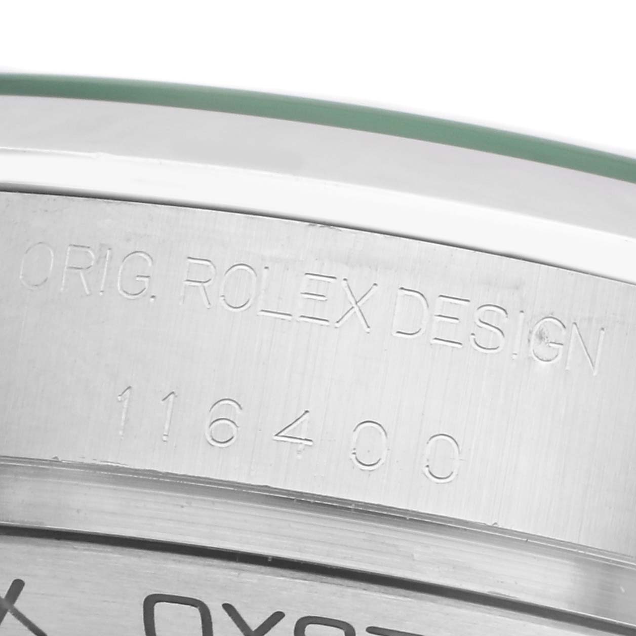 The image shows a close-up of the Milgauss model by Rolex, focusing on the engraved bezel with the design and model number.