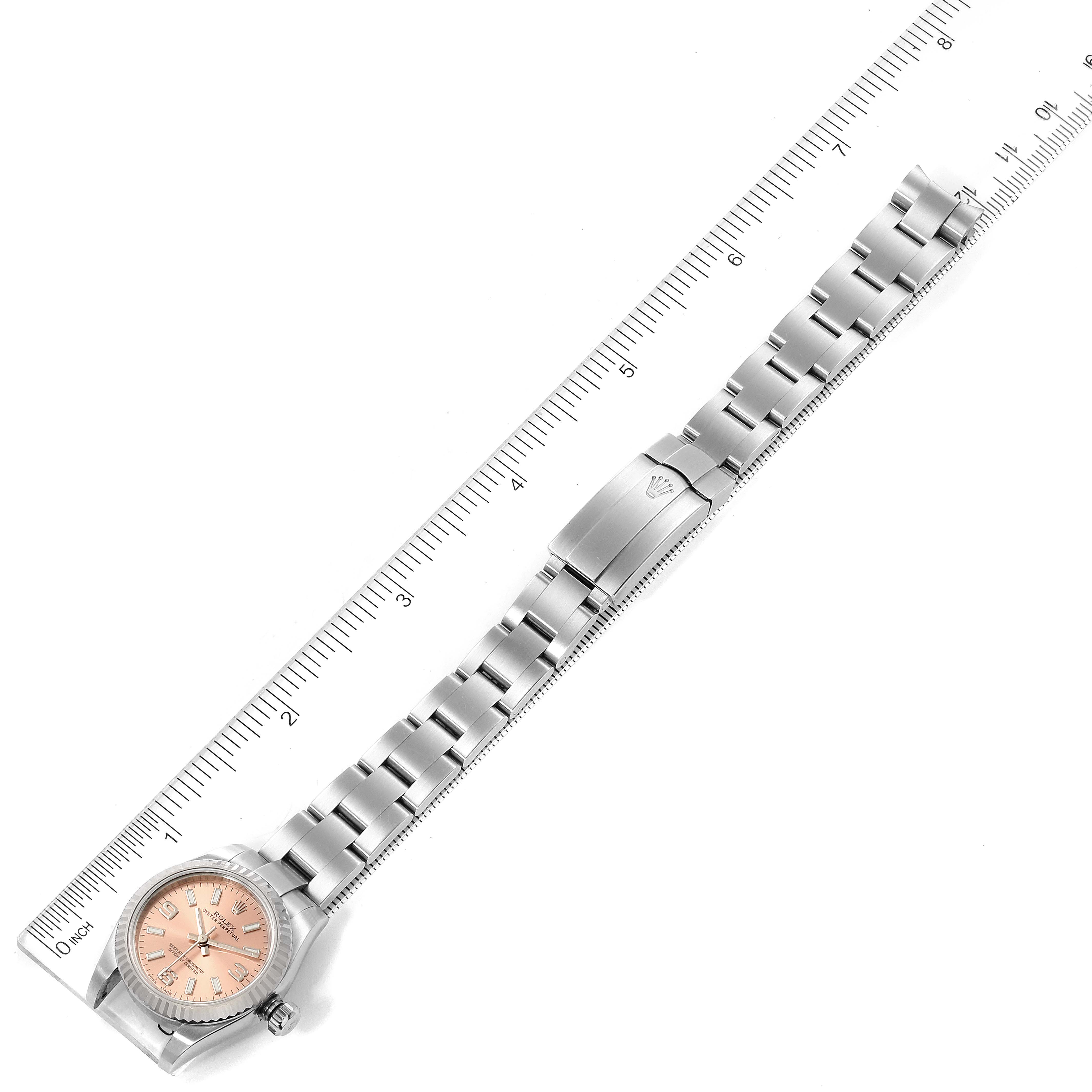 The Rolex Datejust 176234 Women's Stainless Steel Pink Dial 176234 Women's Stainless Steel Pink Dial watch is shown at a flat angle, including the dial, bracelet, and clasp, aligned next to a ruler.