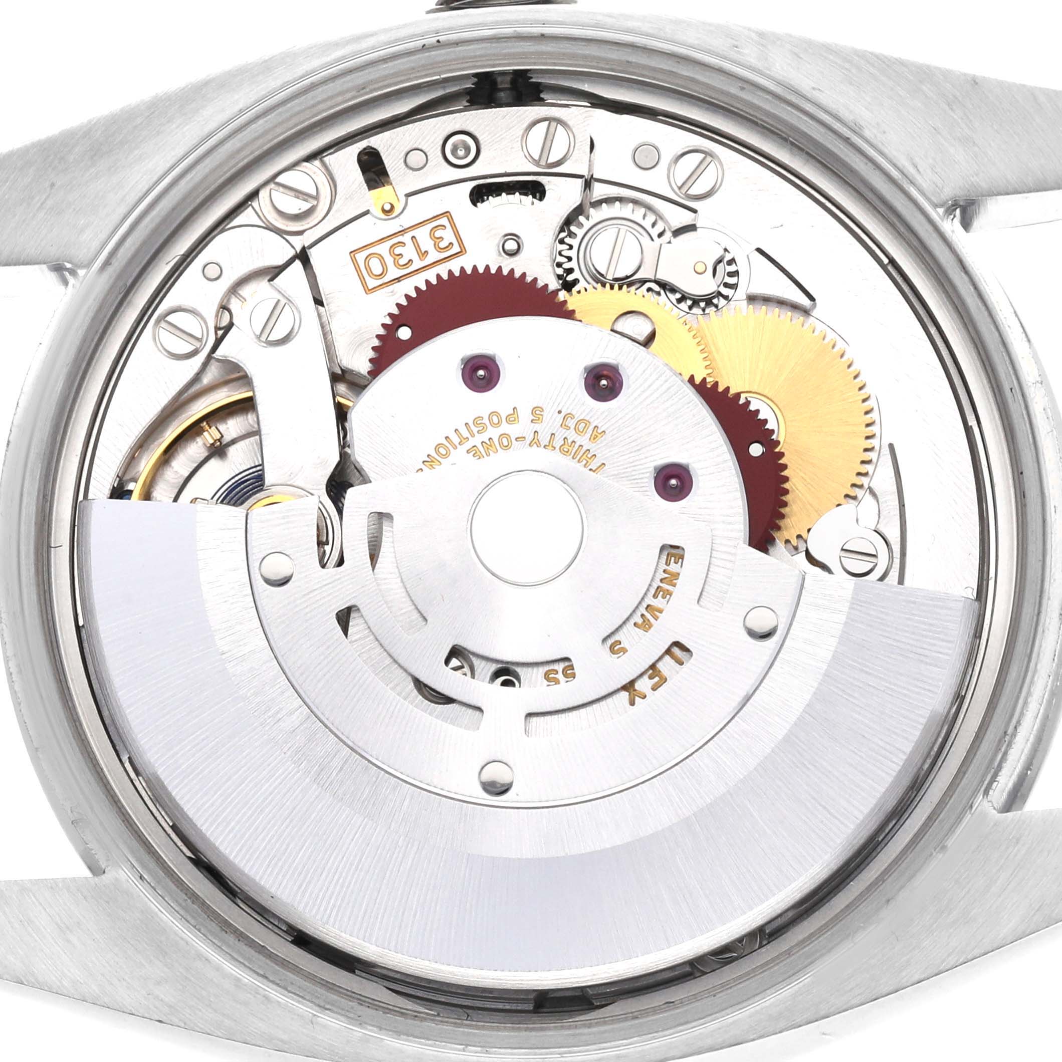 This image shows the internal mechanical movement of a Rolex Oyster Perpetual 114200 Men's Stainless Steel Champagne Dial 114200 Men's Stainless Steel Champagne Dial watch from a straight-on angle.