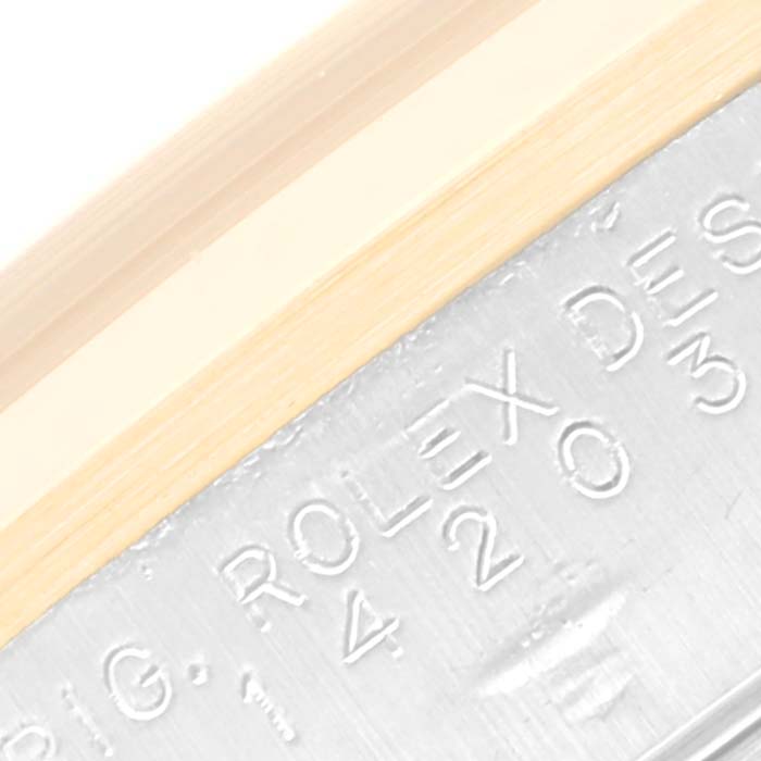 The image shows a close-up of the engraved text on the metallic part of a Rolex Oyster Perpetual 14203 Men's Steel and Gold (two tone) Grey Dial 14203 Men's Steel and Gold (two tone) Grey Dial watch.