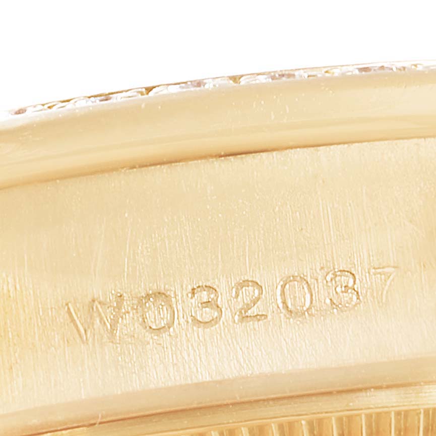 This close-up image shows the engraved serial number on the polished gold surface of a Rolex President 69158 Women
s Yellow Gold Mother of Pearl Dial 69158 Women
s Yellow Gold Mother of Pearl Dial model watch.