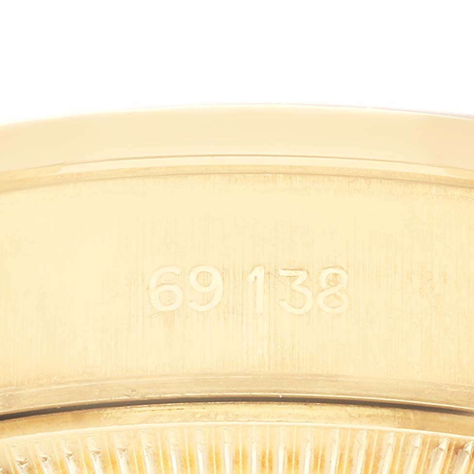 The image shows a close-up view of the model number 69138 engraved on the side of a Rolex President 69138G Women
s Yellow Gold Champagne Dial 69138G Women
s Yellow Gold Champagne Dial watch.