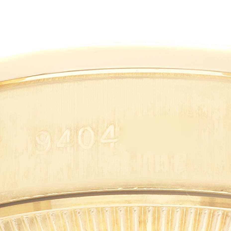 This close-up image of a Rolex President 69138G Women
s Yellow Gold Champagne Dial 69138G Women
s Yellow Gold Champagne Dial model watch shows the caseback with the serial number partially visible.