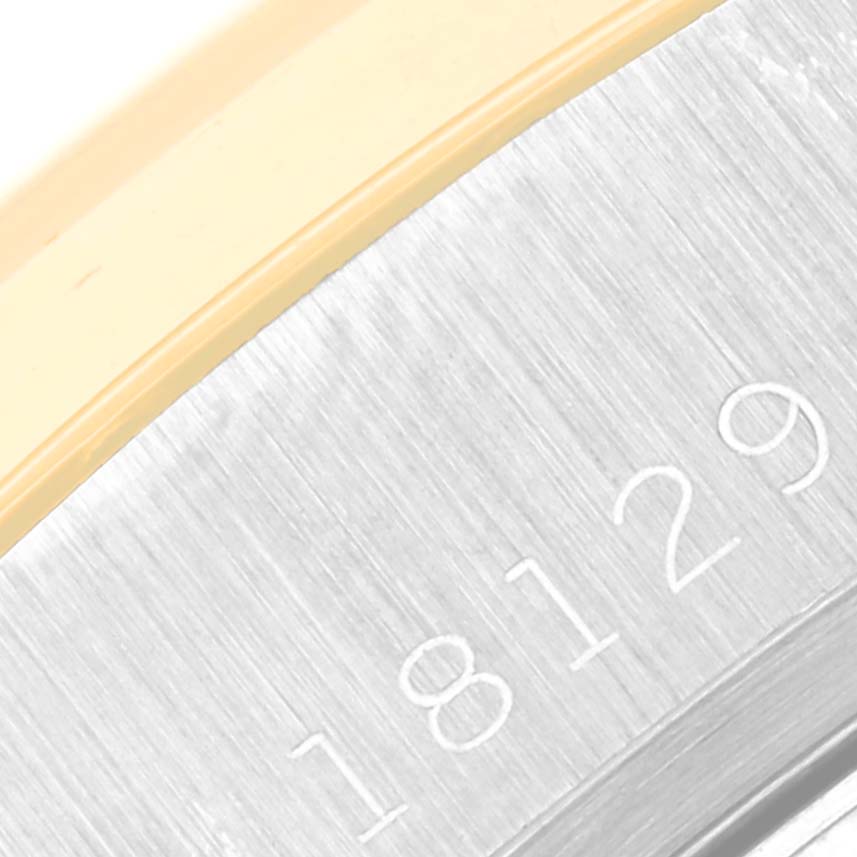 The image shows a close-up of the engraved serial number and part of the bezel of the Rolex President 18129 Men's White Gold Champagne Dial 18129 Men's White Gold Champagne Dial model watch.