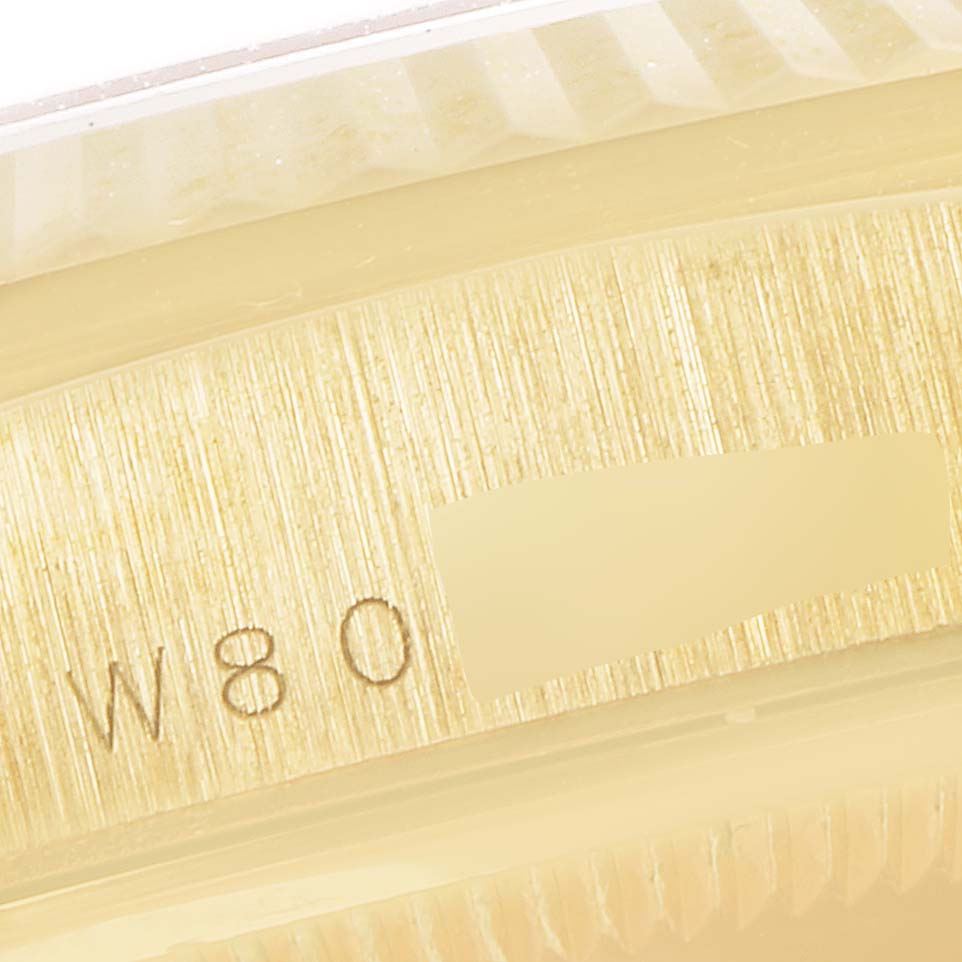 This image shows a close-up of the side engraving and edge of the bezel on a Rolex President 18238 Men's Yellow Gold Blue Dial 18238 Men's Yellow Gold Blue Dial model watch.