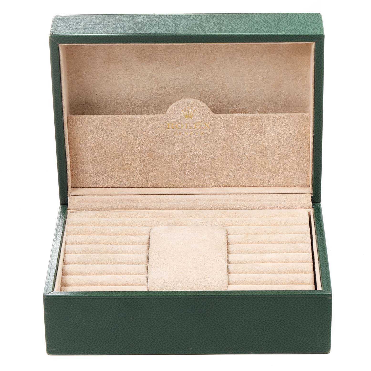This image shows an open Rolex watch box for the President model, revealing its beige interior and green exterior.