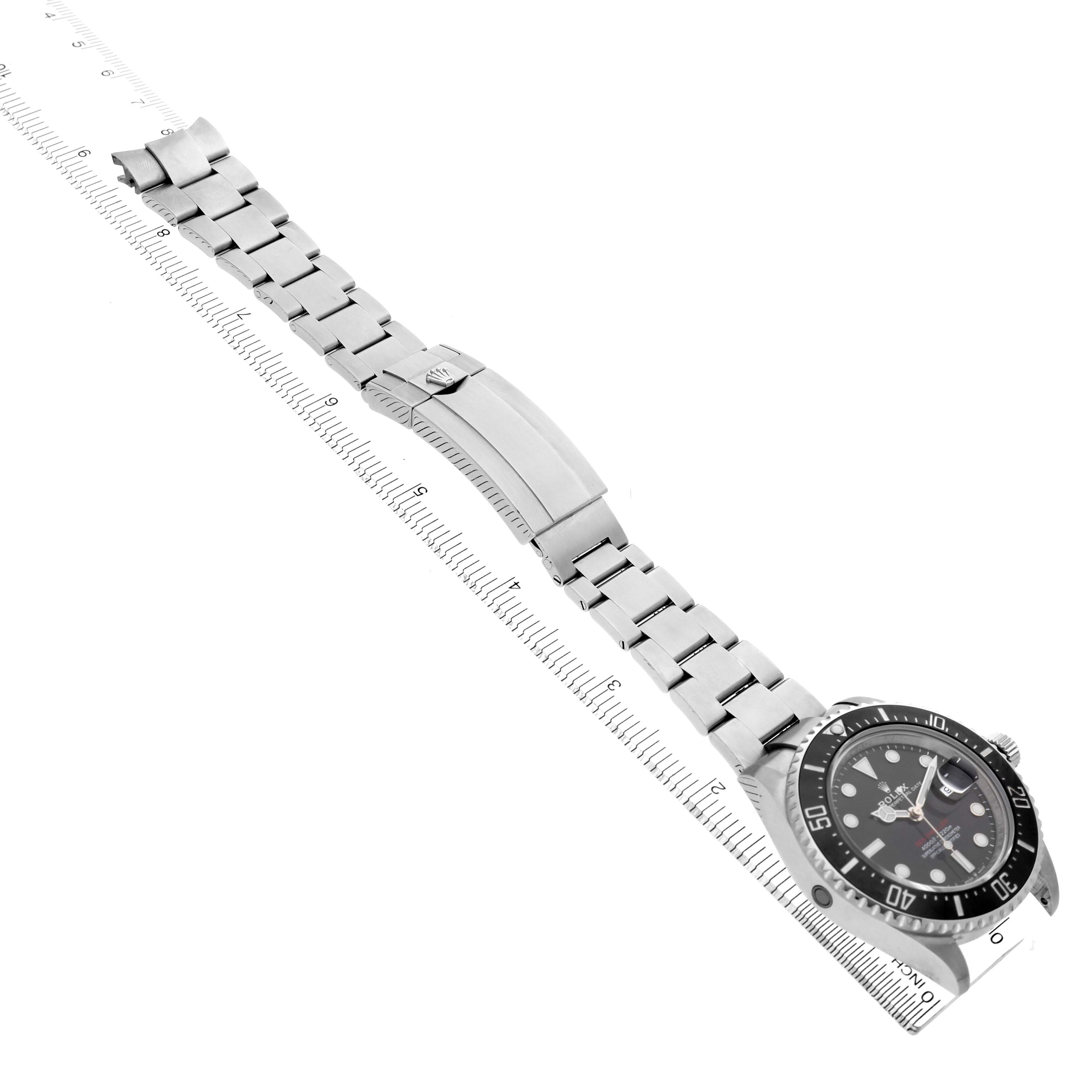The Rolex Sea-Dweller 126600 Men's Stainless Steel Black Dial is shown at an angled top view, displaying the bracelet and clasp alongside a ruler for size reference.