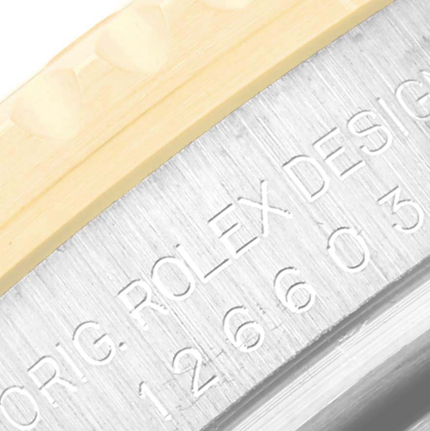 This image shows a close-up of the engraved side of the Rolex Sea-Dweller 126603 Men
s Steel and Gold (two tone) Black Dial 126603 Men
s Steel and Gold (two tone) Black Dial model, featuring part of the bezel and case.