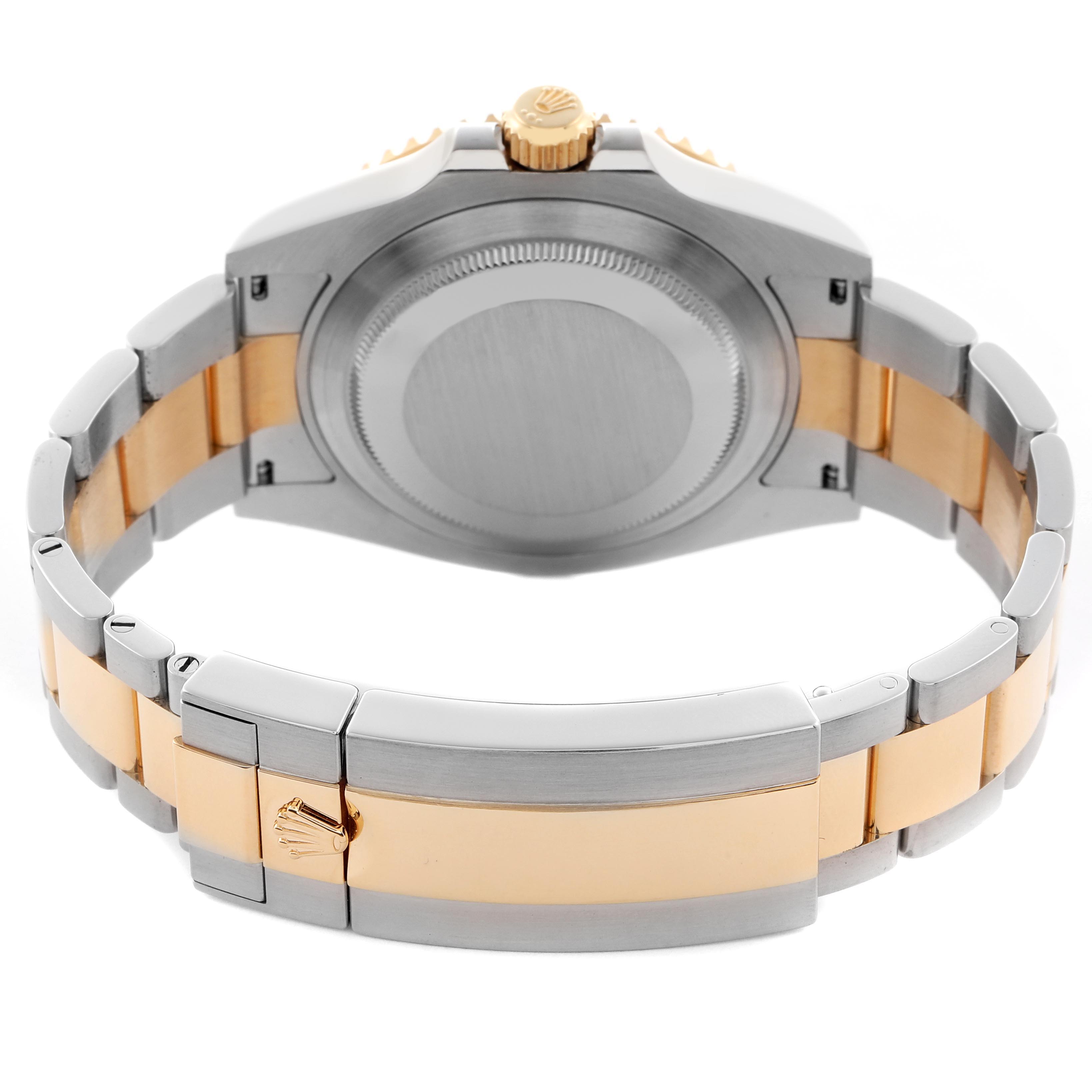 The image shows the Rolex Submariner 126613 Men
s Steel and Gold (two tone) Blue Dial 126613 Men
s Steel and Gold (two tone) Blue Dial from the rear, highlighting the case back, crown, and two-tone bracelet.