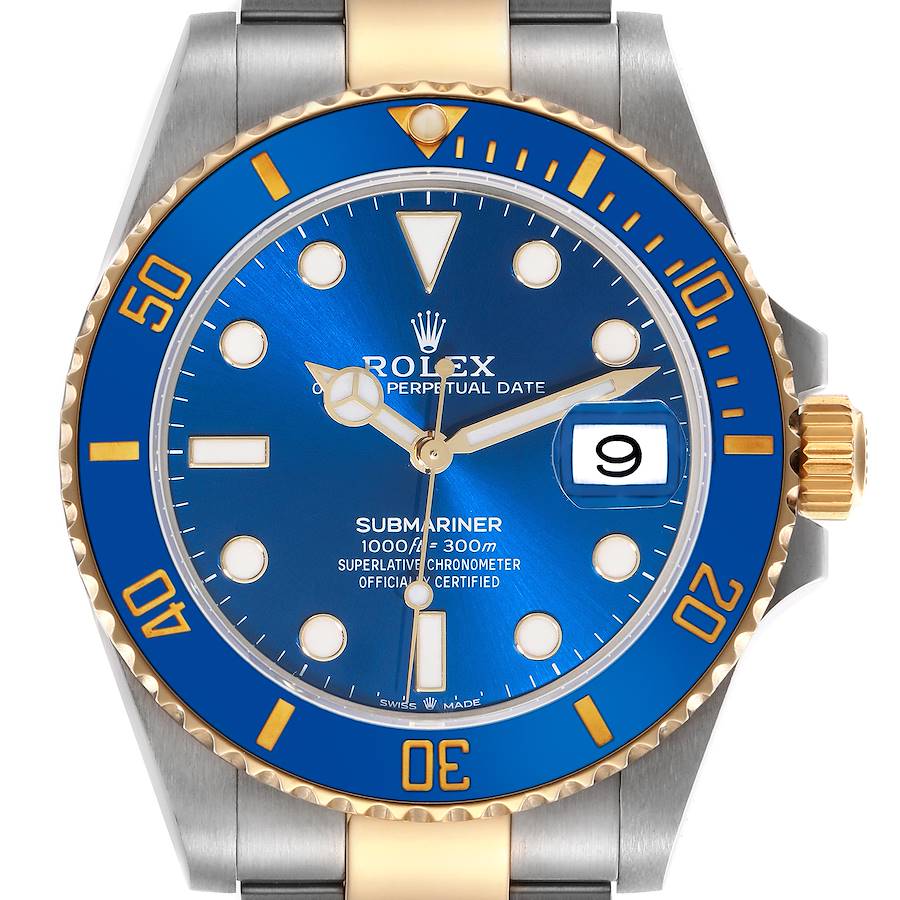 The Rolex Submariner watch is shown from a front view, highlighting the blue dial, gold bezel, date, and two-tone bracelet.