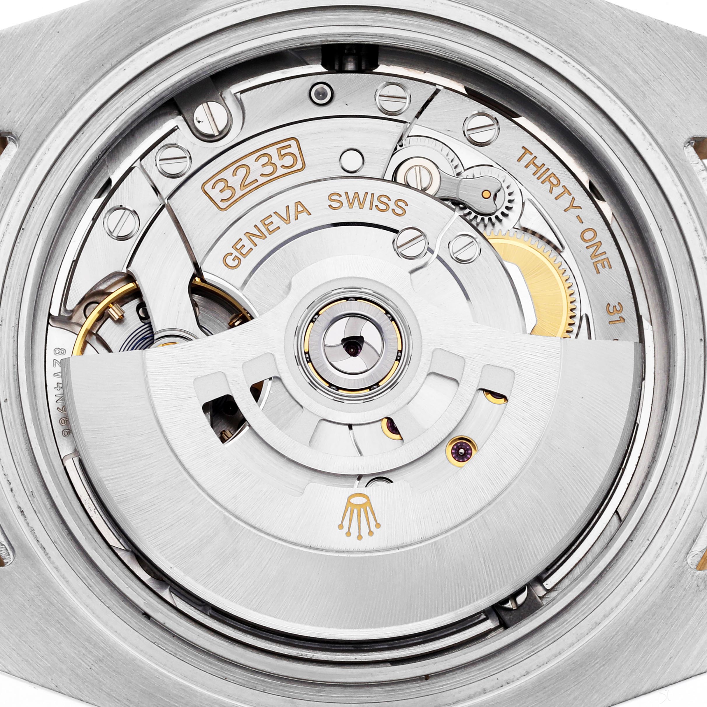 The image shows the movement of a Rolex Submariner 126613 Men
s Steel and Gold (two tone) Blue Dial 126613 Men
s Steel and Gold (two tone) Blue Dial, focusing on its intricate mechanical parts.