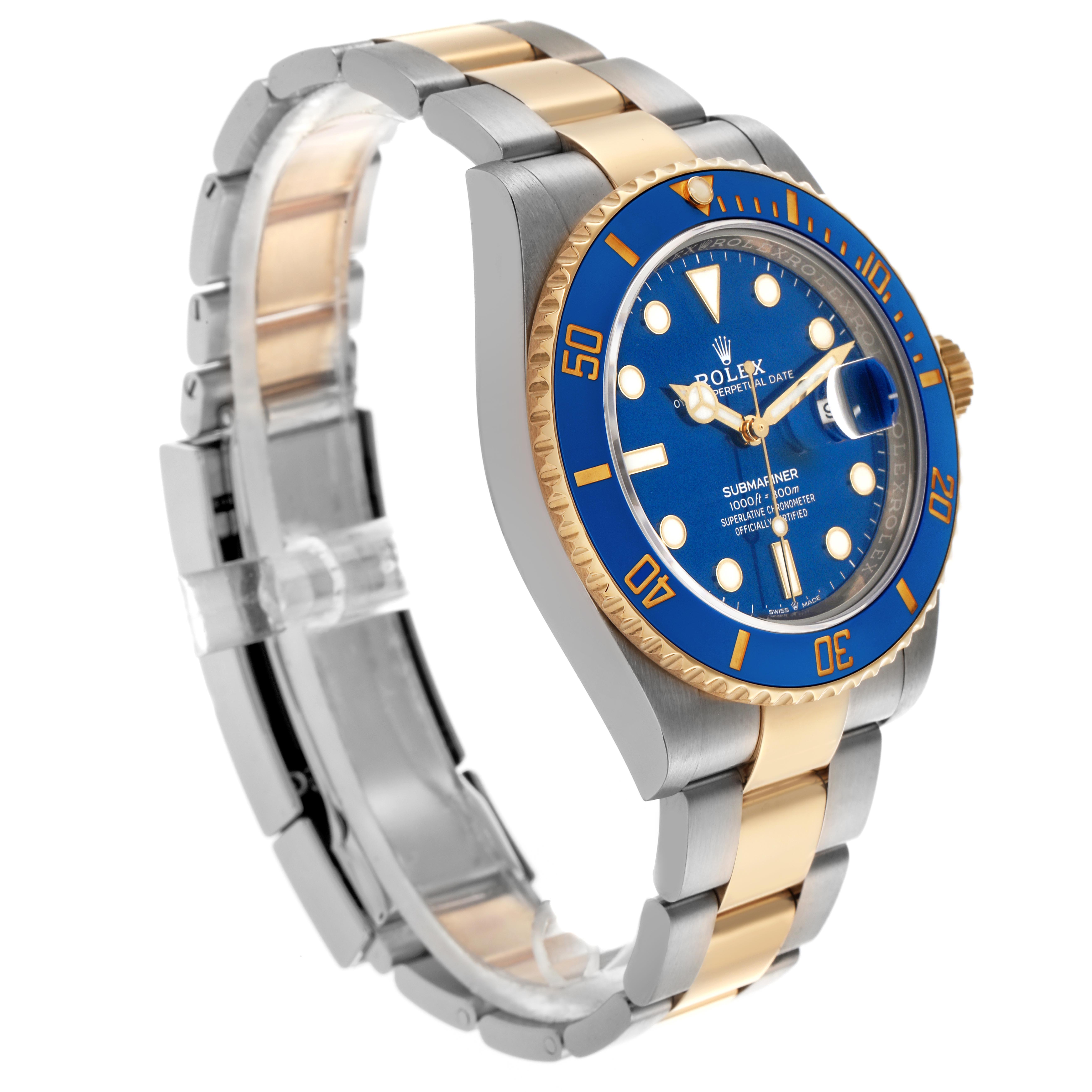 The Rolex Submariner 126613 Men
s Steel and Gold (two tone) Blue Dial 126613 Men
s Steel and Gold (two tone) Blue Dial watch is shown at an oblique angle, highlighting its blue dial, bezel, and two-tone bracelet.
