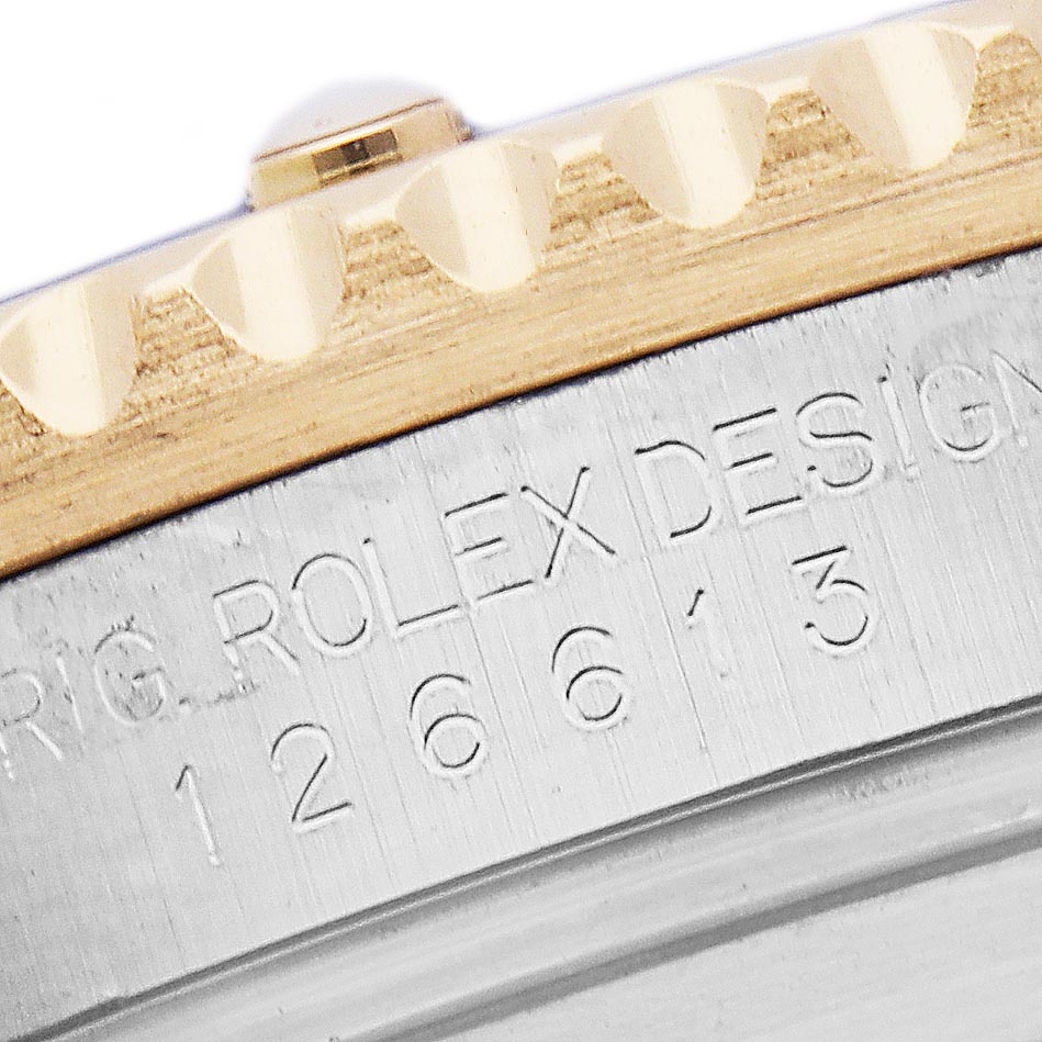 The image shows a close-up of the case engraving and bezel edge of a Rolex Submariner 126613 Men
s Steel and Gold (two tone) Blue Dial 126613 Men
s Steel and Gold (two tone) Blue Dial.