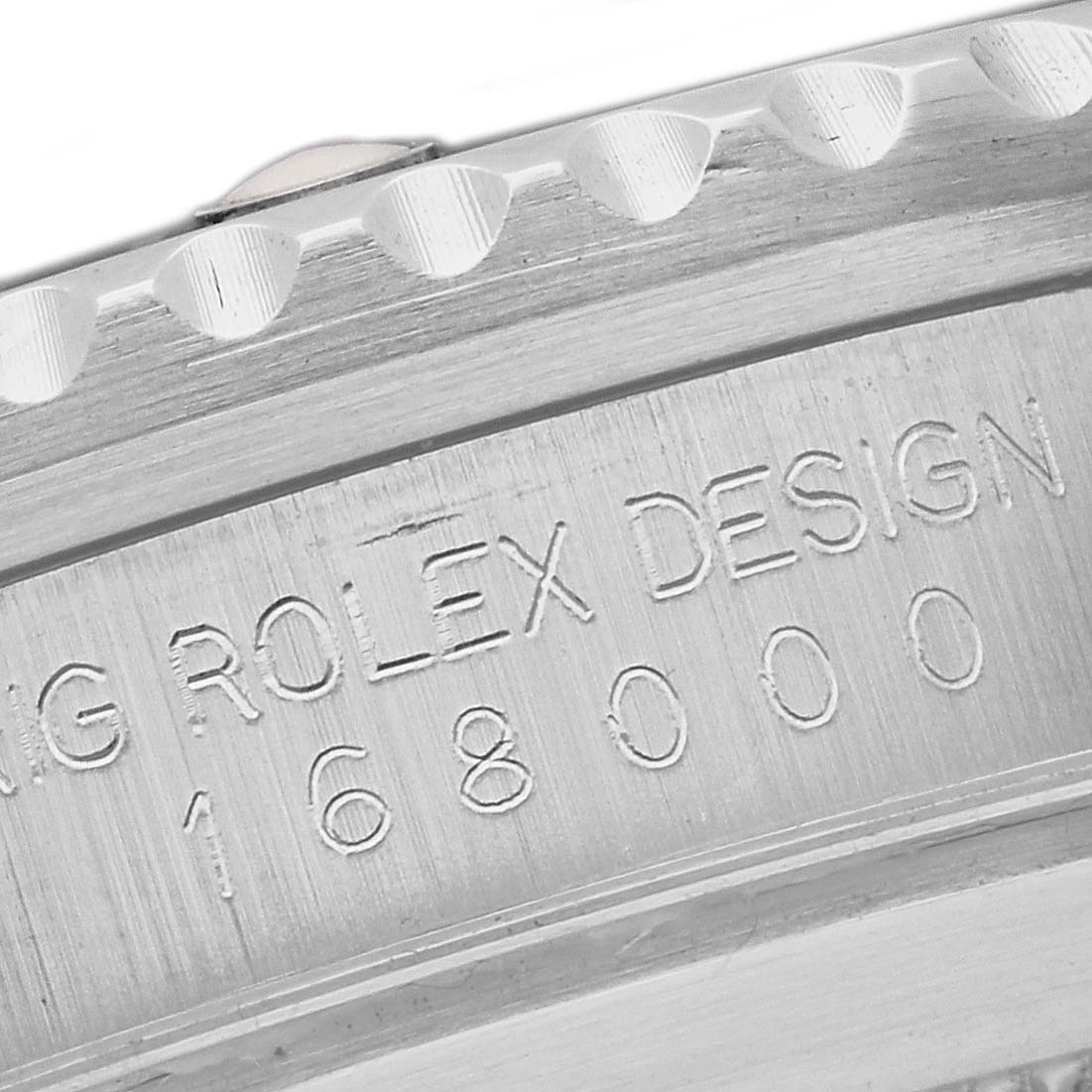 Close-up of the edge and engraved serial number of a Rolex Submariner 168000 Men
s Stainless Steel Black Dial 168000 Men
s Stainless Steel Black Dial watch.