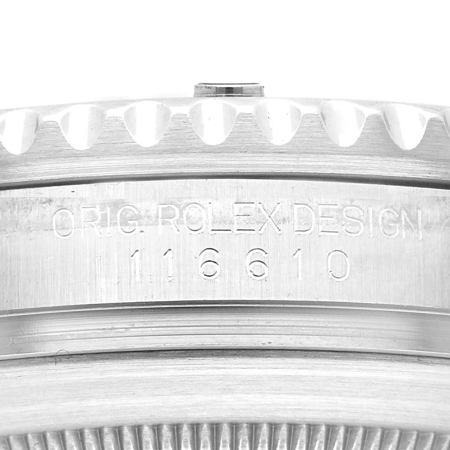 This close-up image shows the engraved serial number and edge of the bezel of a Rolex Submariner 116610 Men
s Stainless Steel Black Dial 116610 Men
s Stainless Steel Black Dial watch.