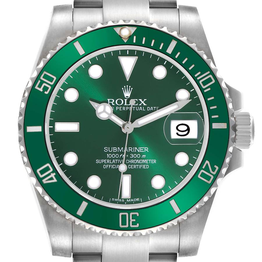 The Rolex Submariner watch is shown from a top-down angle, highlighting the green dial, bezel, and date window.