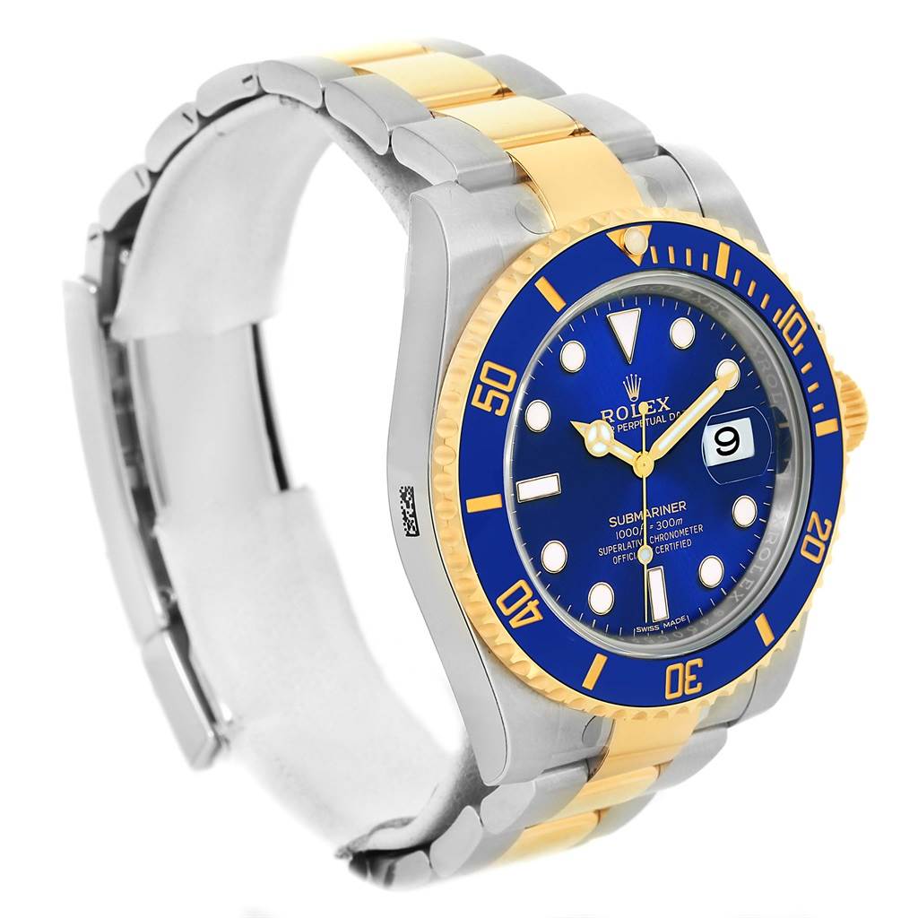 The image shows a Rolex Submariner 116613 Men
s Steel and Gold (two tone) Blue Dial 116613 Men
s Steel and Gold (two tone) Blue Dial watch at a three-quarter angle, highlighting its blue dial, bezel, and two-tone bracelet.