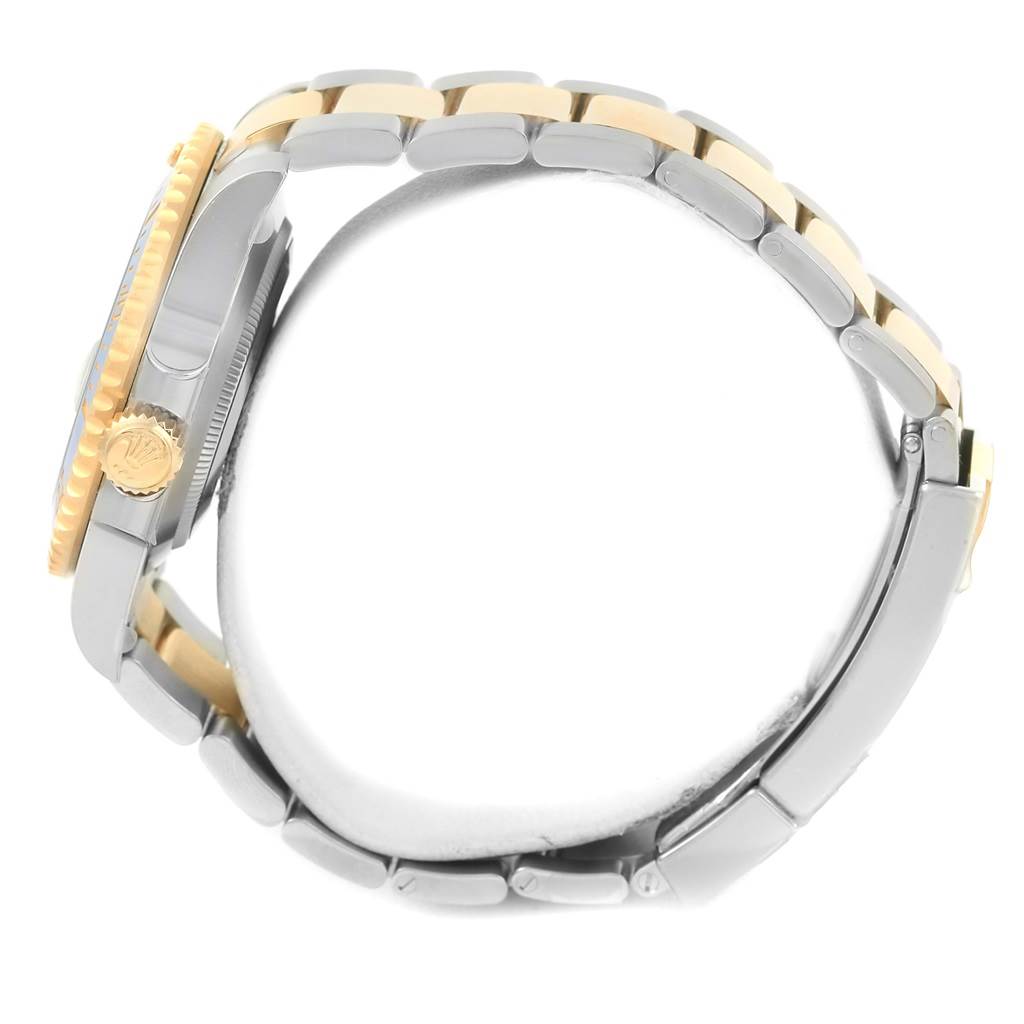 The image shows a side view of a Rolex Submariner 116613 Men
s Steel and Gold (two tone) Blue Dial 116613 Men
s Steel and Gold (two tone) Blue Dial watch, highlighting its case, crown, and bracelet.