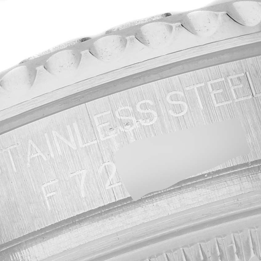 The image shows a close-up of the fluted bezel and engraved case back of a Rolex Yacht-Master 168622 Men's Stainless Steel Silver Dial.