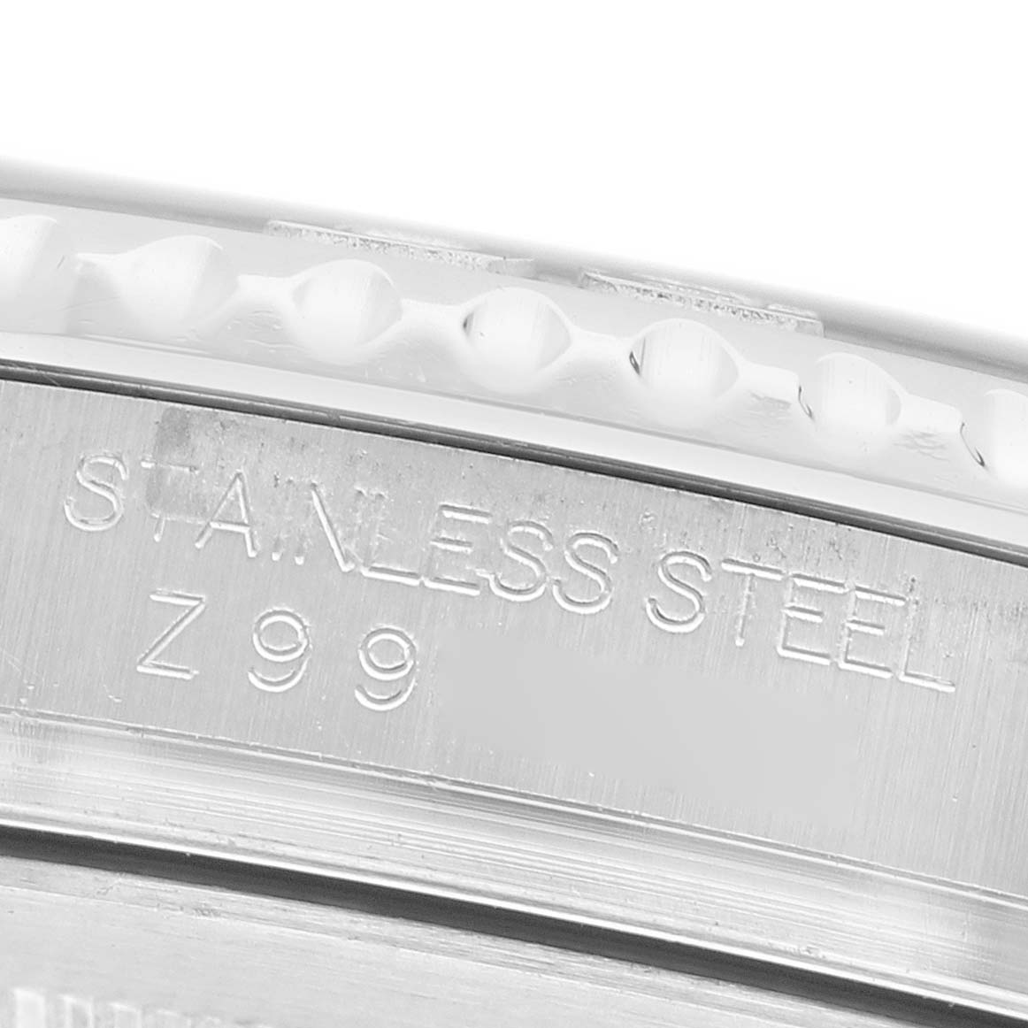 The image shows a close-up of the side of a Rolex Yacht-Master 16622 Men's Stainless Steel Silver Dial, focusing on the engraved "STAINLESS STEEL" marking.