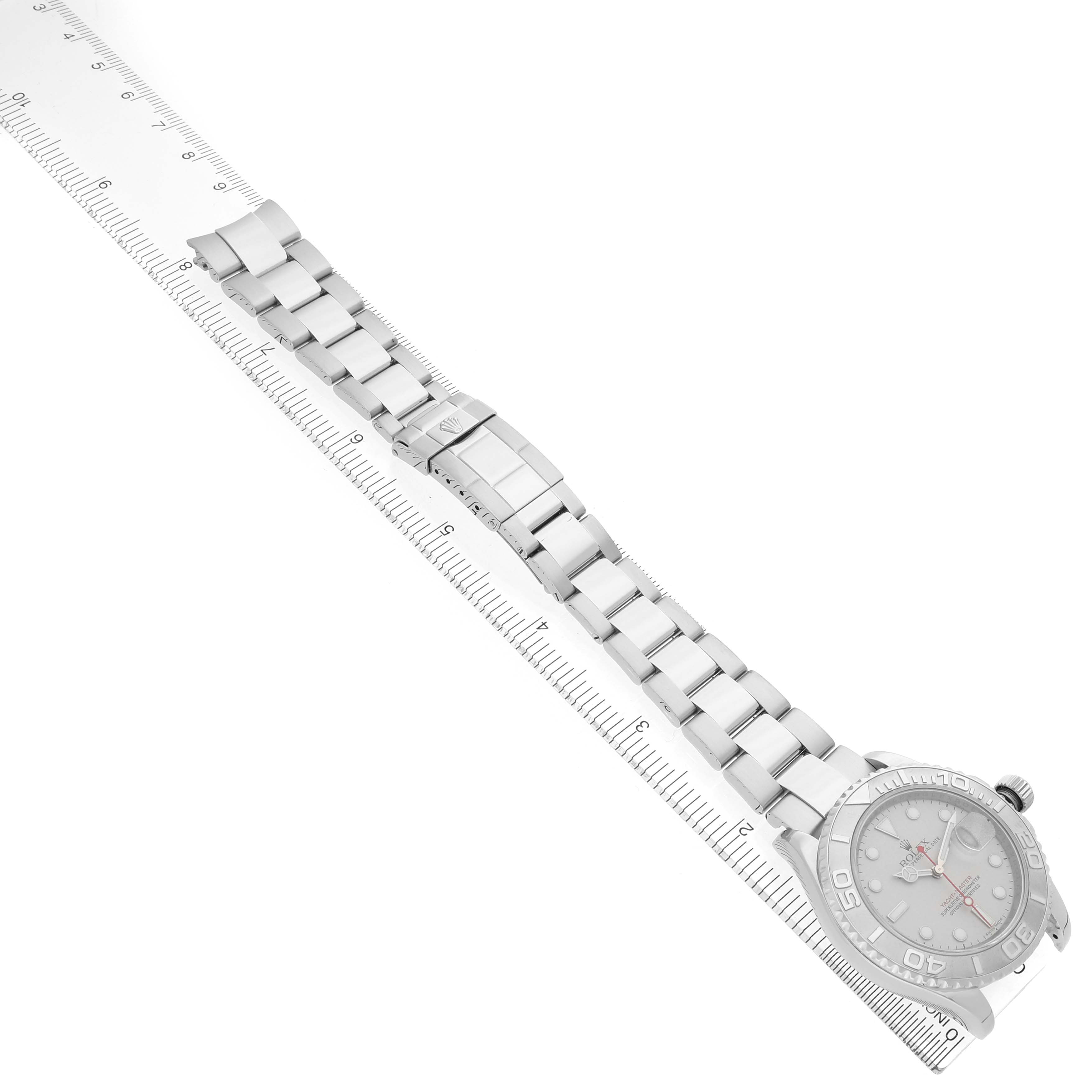The Rolex Yacht-Master 16622 Men's Stainless Steel Silver Dial watch is displayed at a diagonal angle showing the bracelet and face alongside a ruler for scale.
