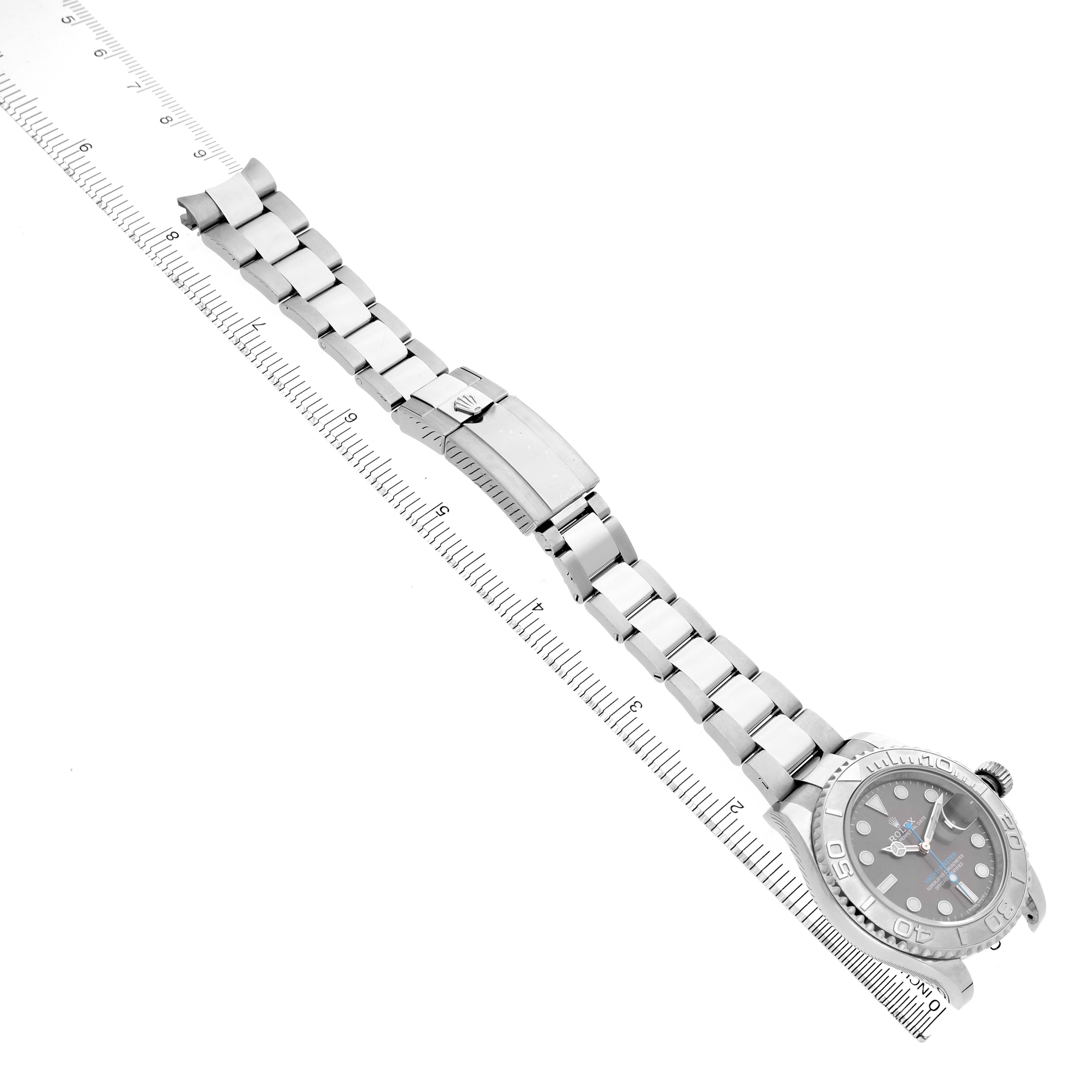 The image shows a top-down view of a Rolex Yacht-Master 116622 Men's Stainless Steel Silver Dial watch, displaying the dial, bezel, bracelet, and clasp alongside a ruler.