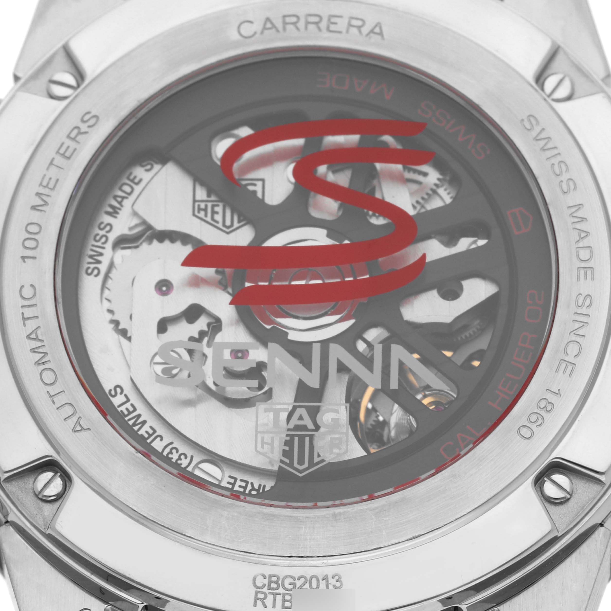 The image shows the back view of a Tag Heuer Carrera CBG2013 Men's Stainless Steel Black Dial CBG2013 Men's Stainless Steel Black Dial watch, highlighting its automatic movement and "Senna" branding.
