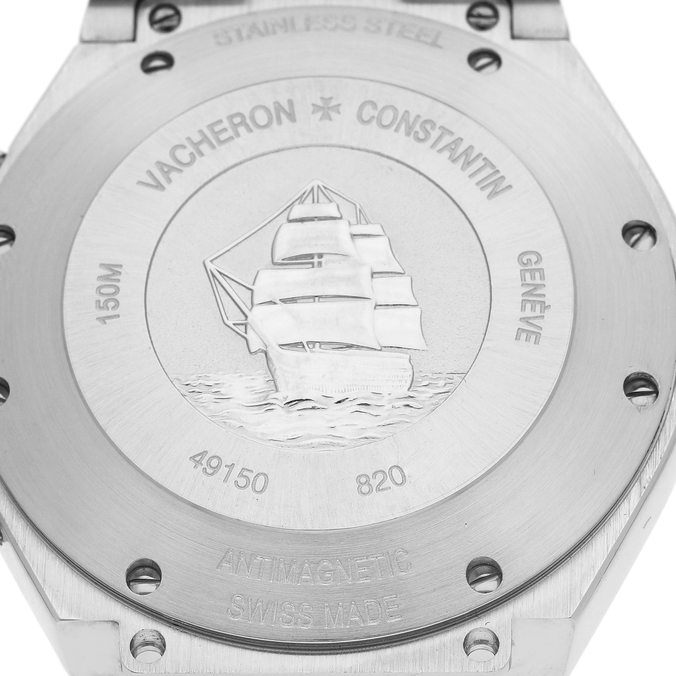 The image shows the case back of the Vacheron Constantin Overseas 49150/B01A-9097 Men's Stainless Steel Black Dial 49150/B01A-9097 Men's Stainless Steel Black Dial watch, featuring a ship engraving and various inscriptions.