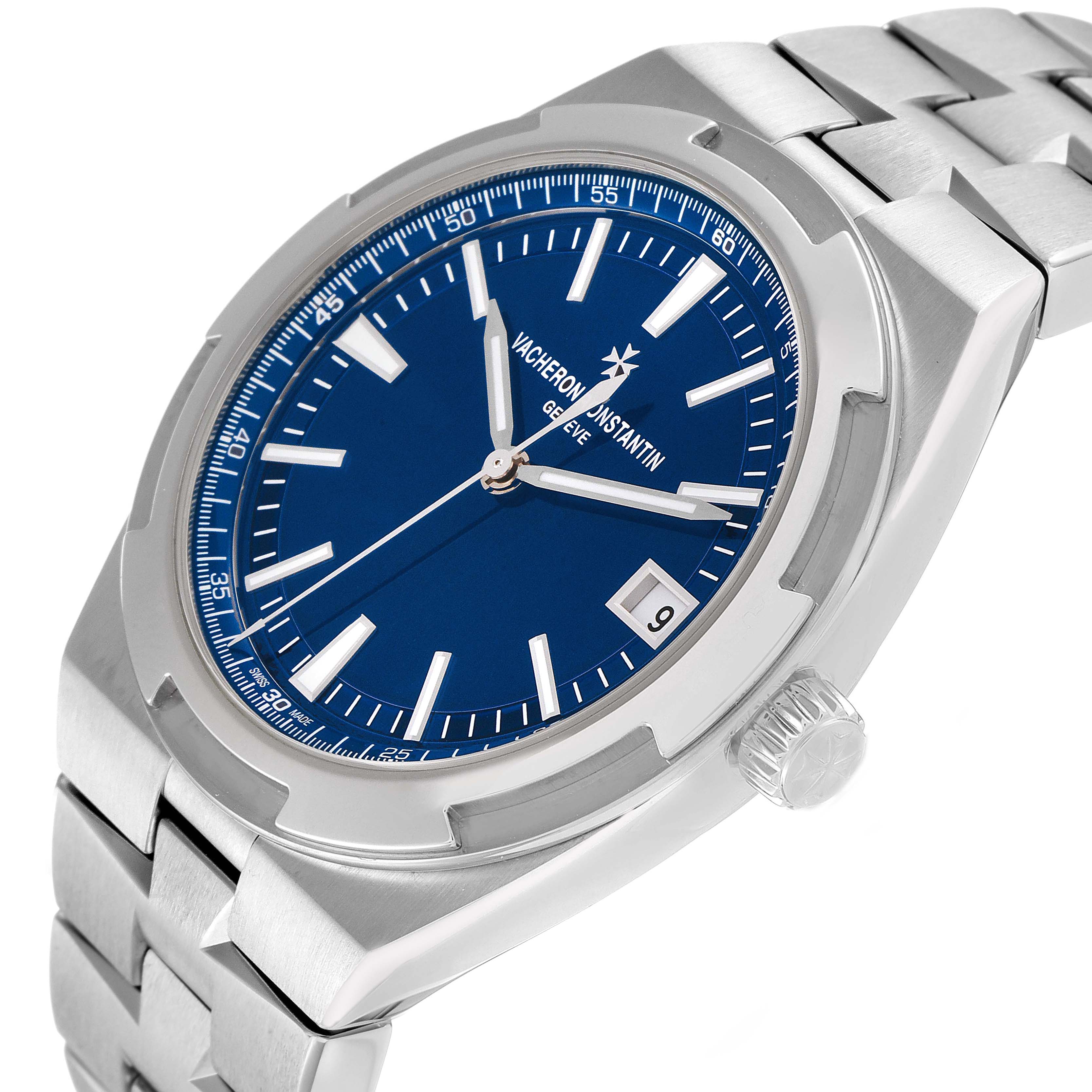 The Vacheron Constantin Overseas 4500V Mens Stainless Steel Blue Dial watch is shown at an angled side view, highlighting the blue dial, date, crown, and stainless steel bracelet.