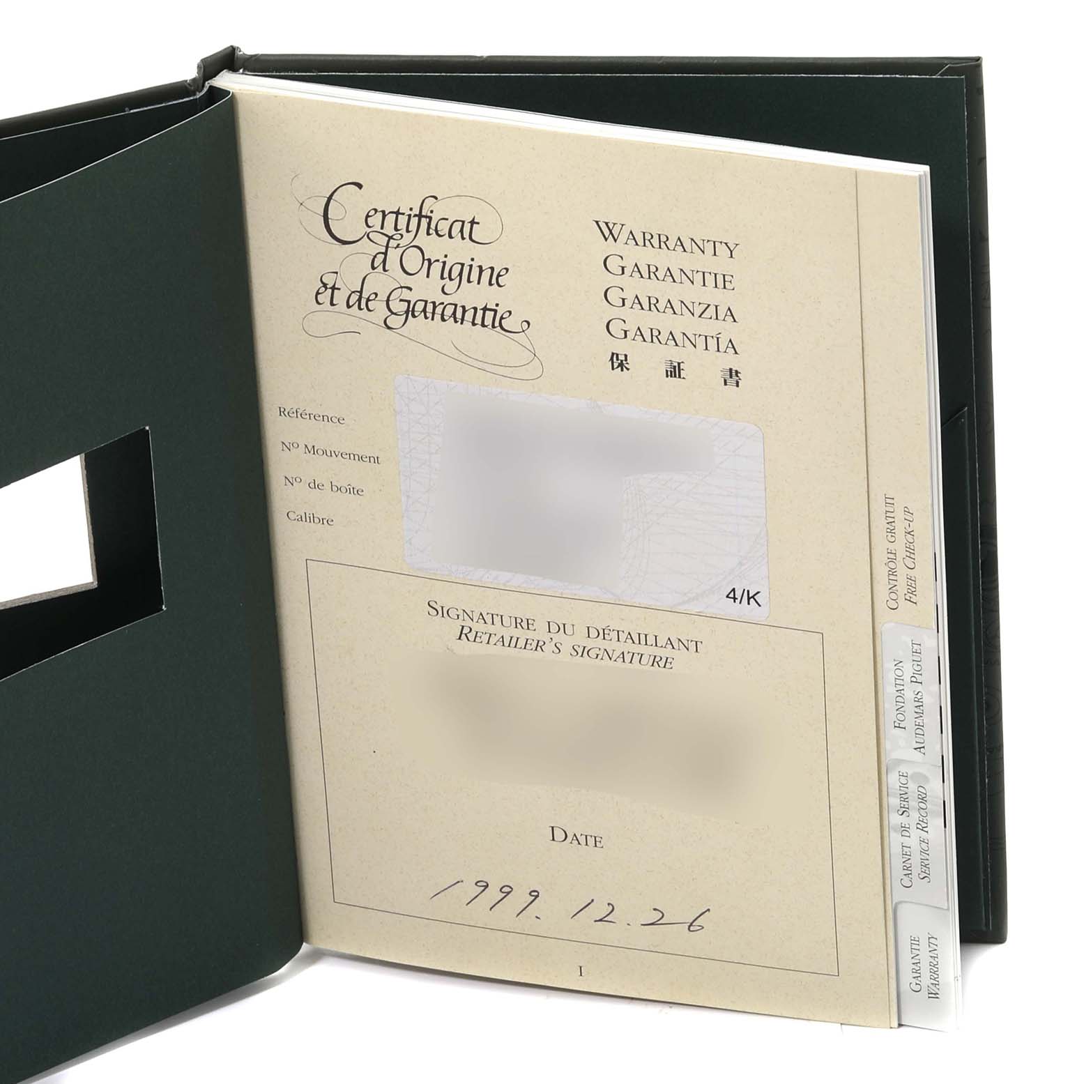 This image shows the warranty and certificate of origin for a Royal Oak model by Audemars Piguet, viewed at an angle inside a booklet.