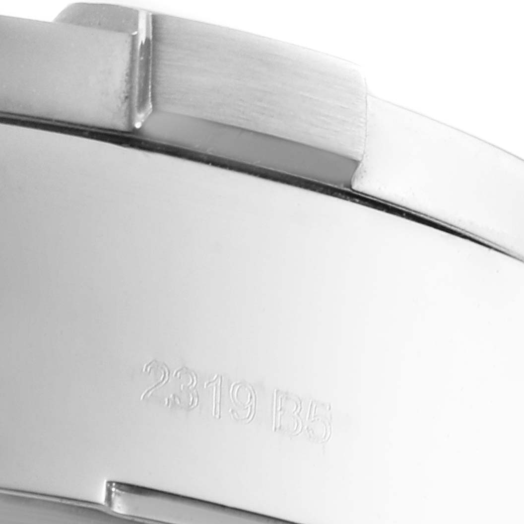 This image shows a close-up of the side of a Breitling Avenger A13371 Men's Stainless Steel Blue Dial A13371 Men's Stainless Steel Blue Dial watch case, focusing on the bezel and engraved serial number.