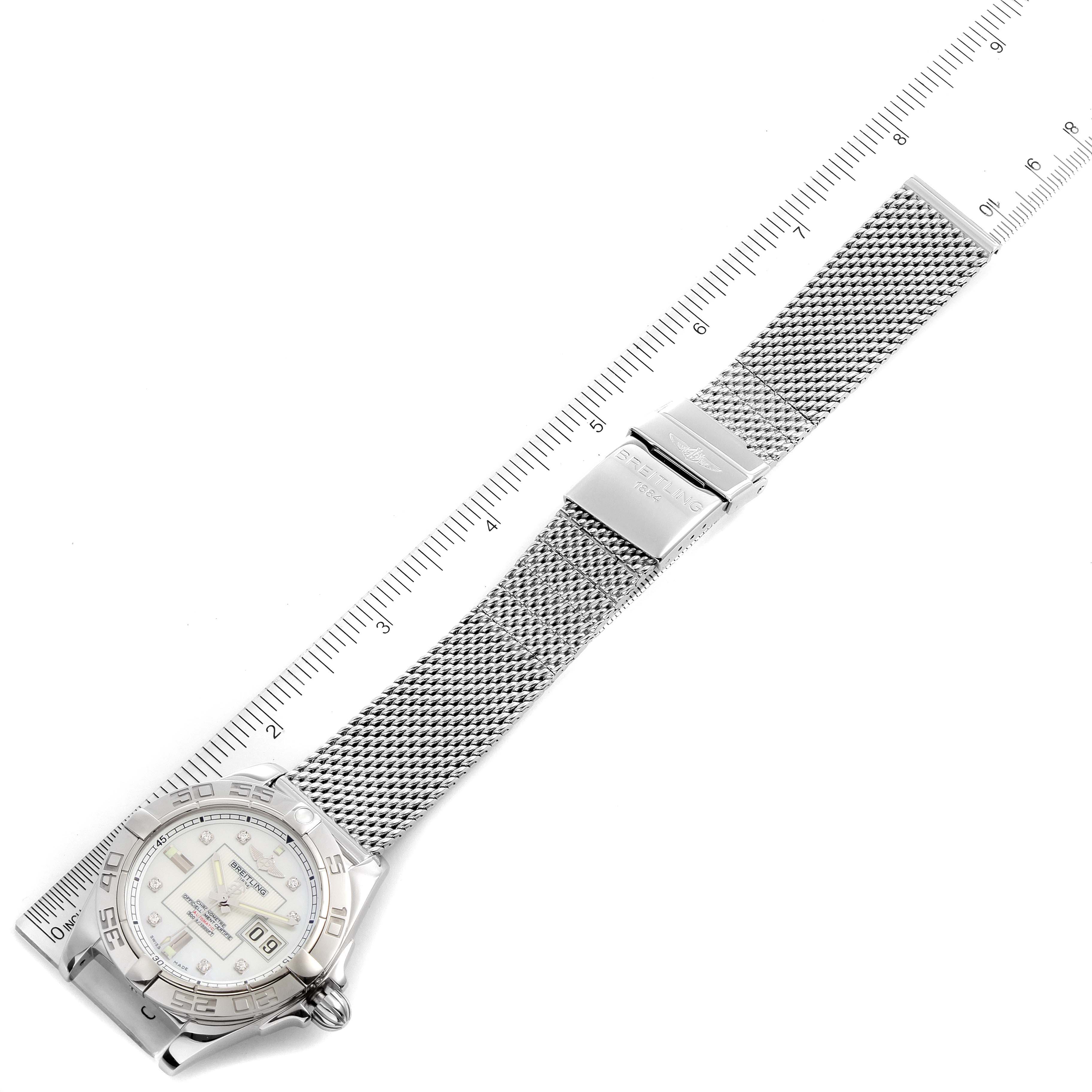 The image shows a top-down view of a Breitling Windrider A49350LA/A702-366A Men's Stainless Steel Mother of Pearl Dial A49350LA/A702-366A Men's Stainless Steel Mother of Pearl Dial watch with its metallic mesh band fully extended alongside a ruler.