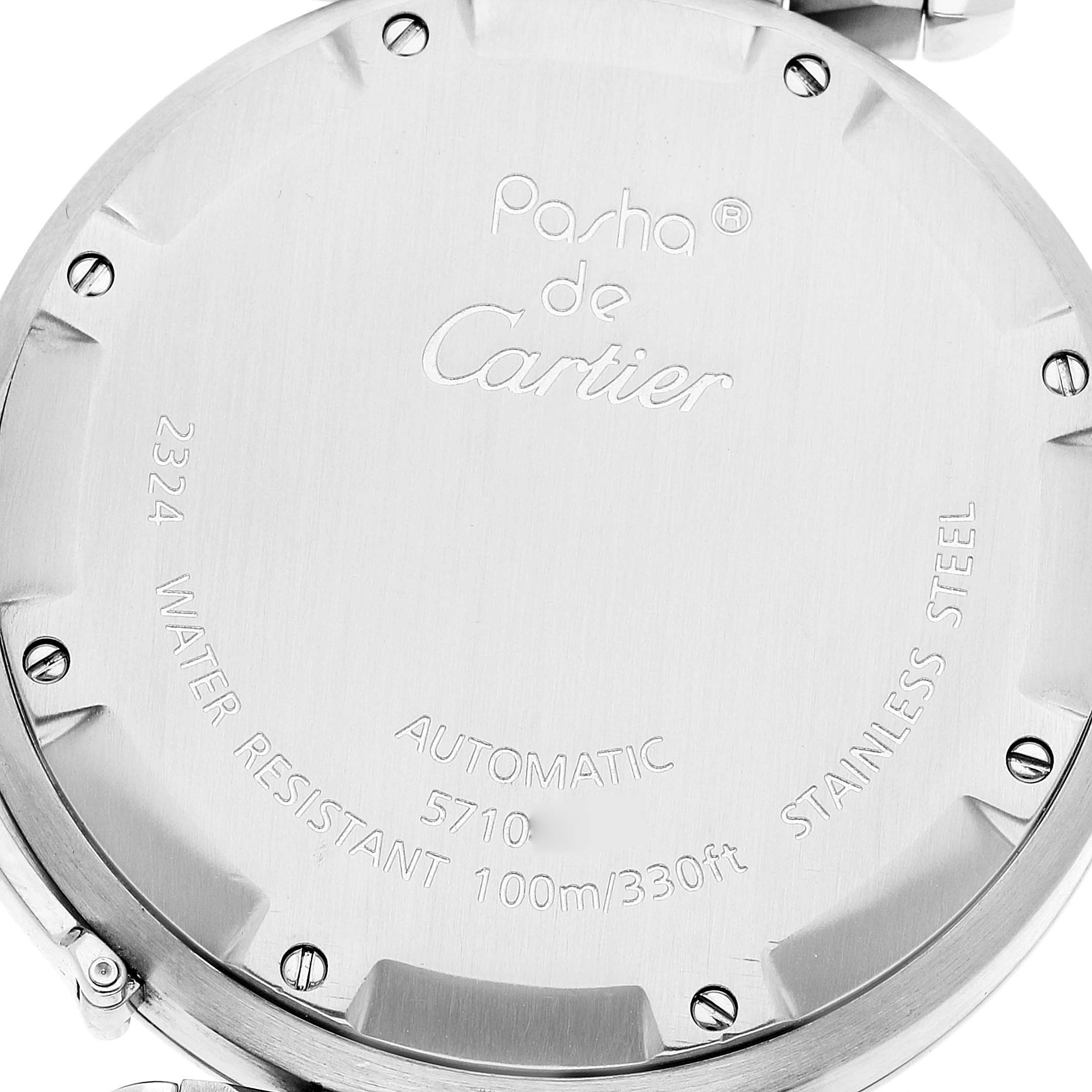 The image shows the back case of a Cartier Pasha W31074M7 Men's Stainless Steel White Dial W31074M7 Men's Stainless Steel White Dial watch, revealing engraved details and screws.