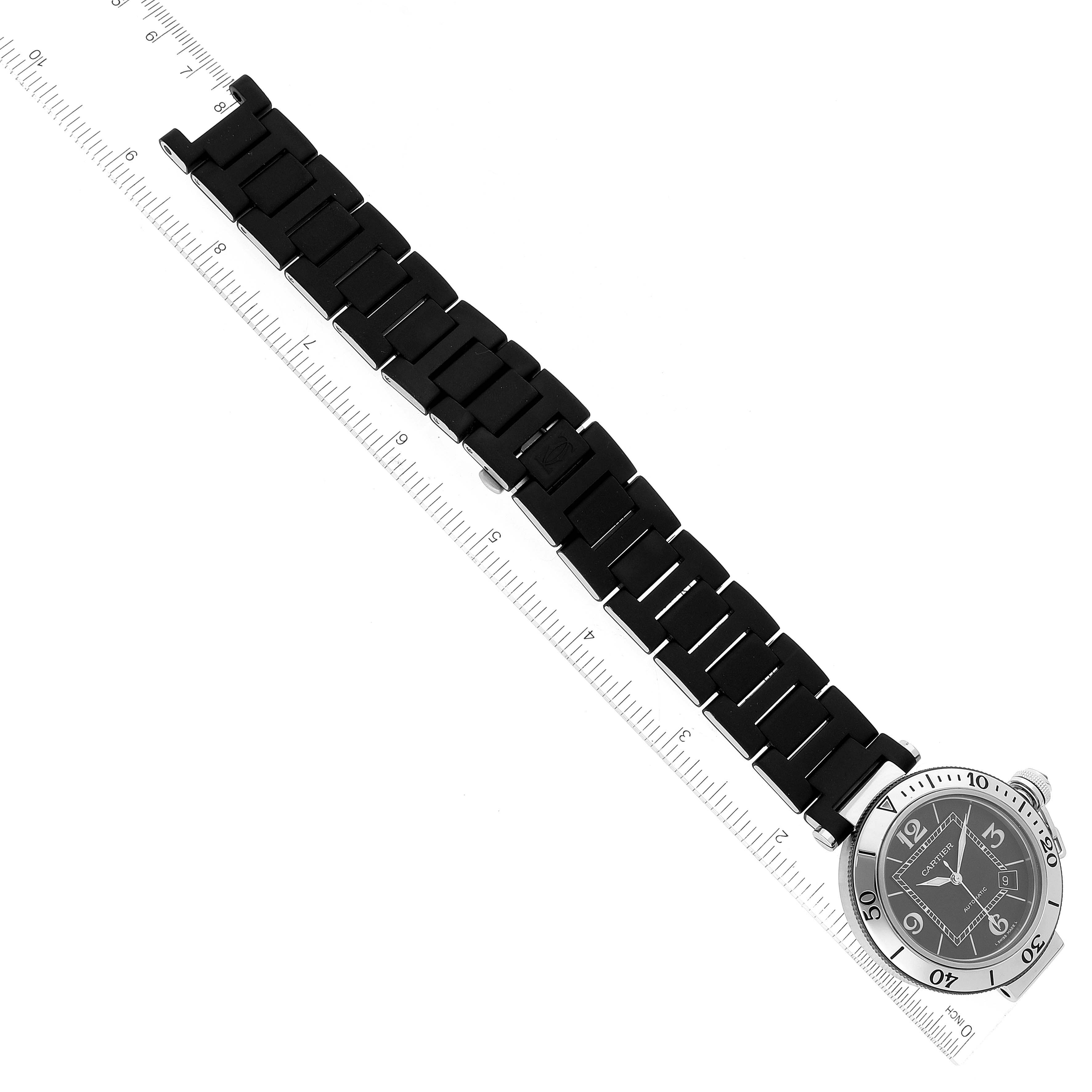 The image shows a top-down view of a Cartier Pasha W31077U2 Men's Stainless Steel Black Dial W31077U2 Men's Stainless Steel Black Dial watch with a black bracelet and a stainless-steel bezel.